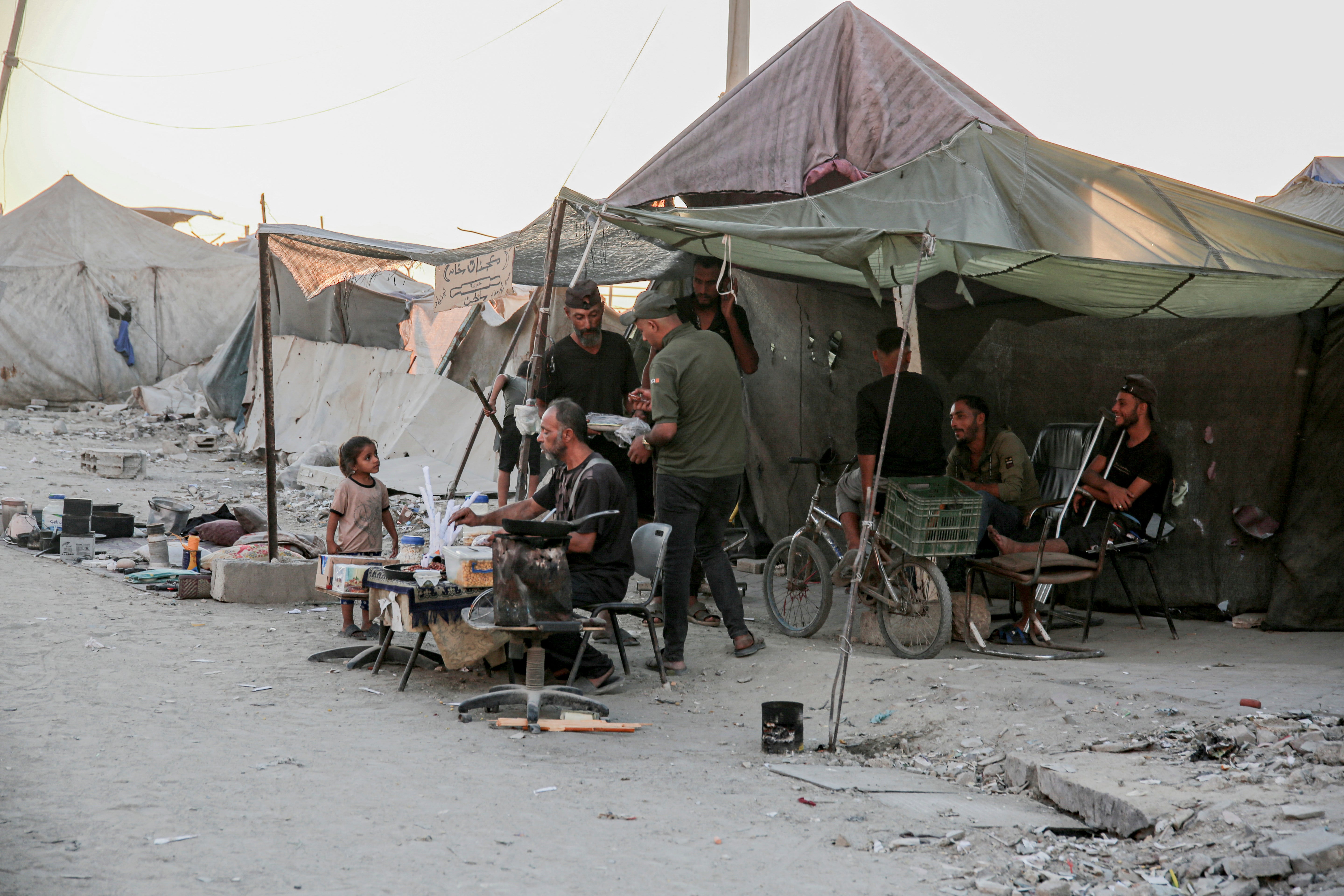 People gather at a makeshift stall in a camp along Al-Rasheed Street in west Gaza City (AFP/Getty)