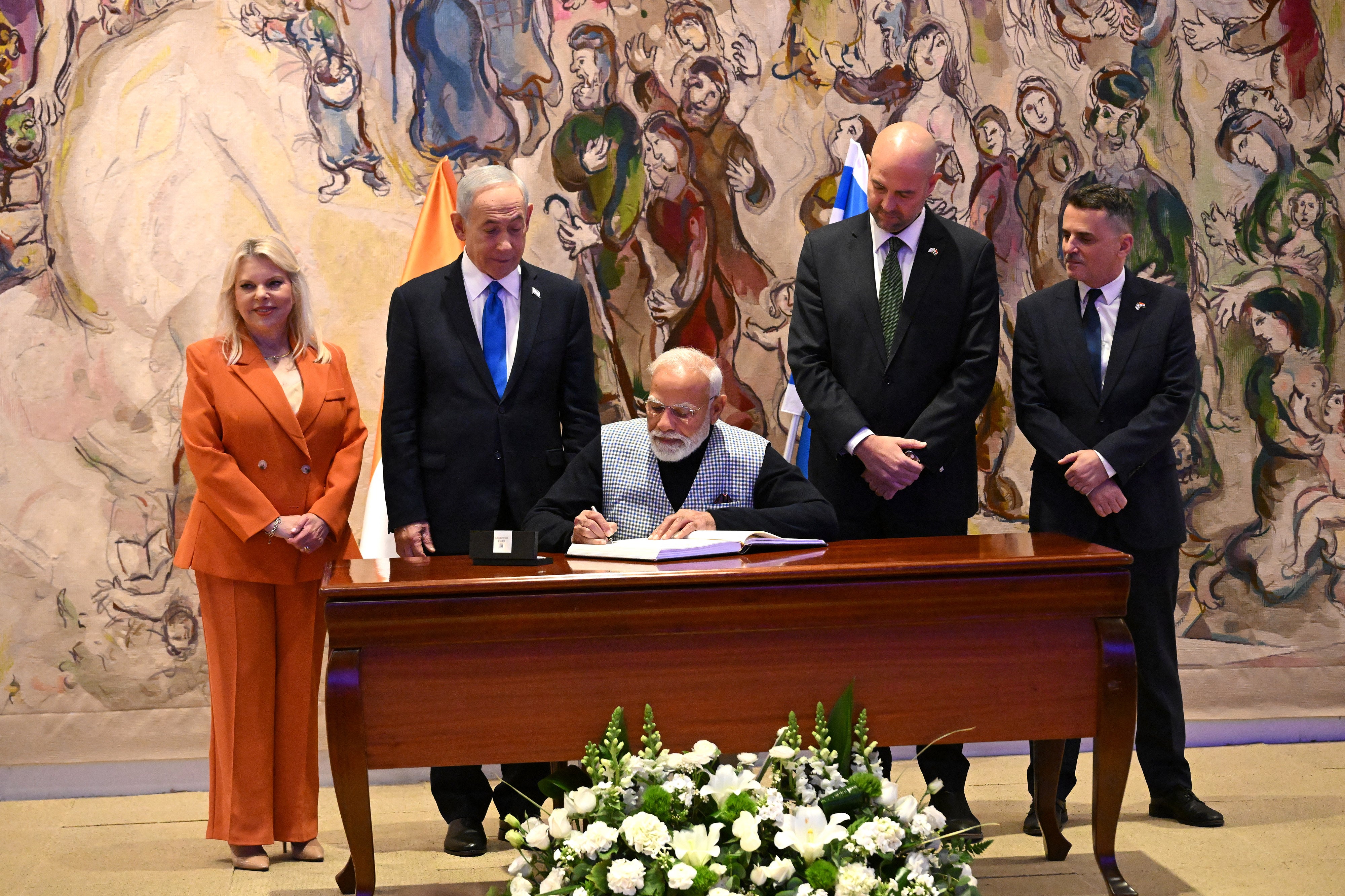 Israeli Prime Minister Benjamin Netanyahu and his wife Sara watch Indian Prime Minister Narendra Modi sign the guestbook in the Chagall Hall in the Knesset, the Parliament, in Jerusalem on February 25, 2026 (AFP/Getty)