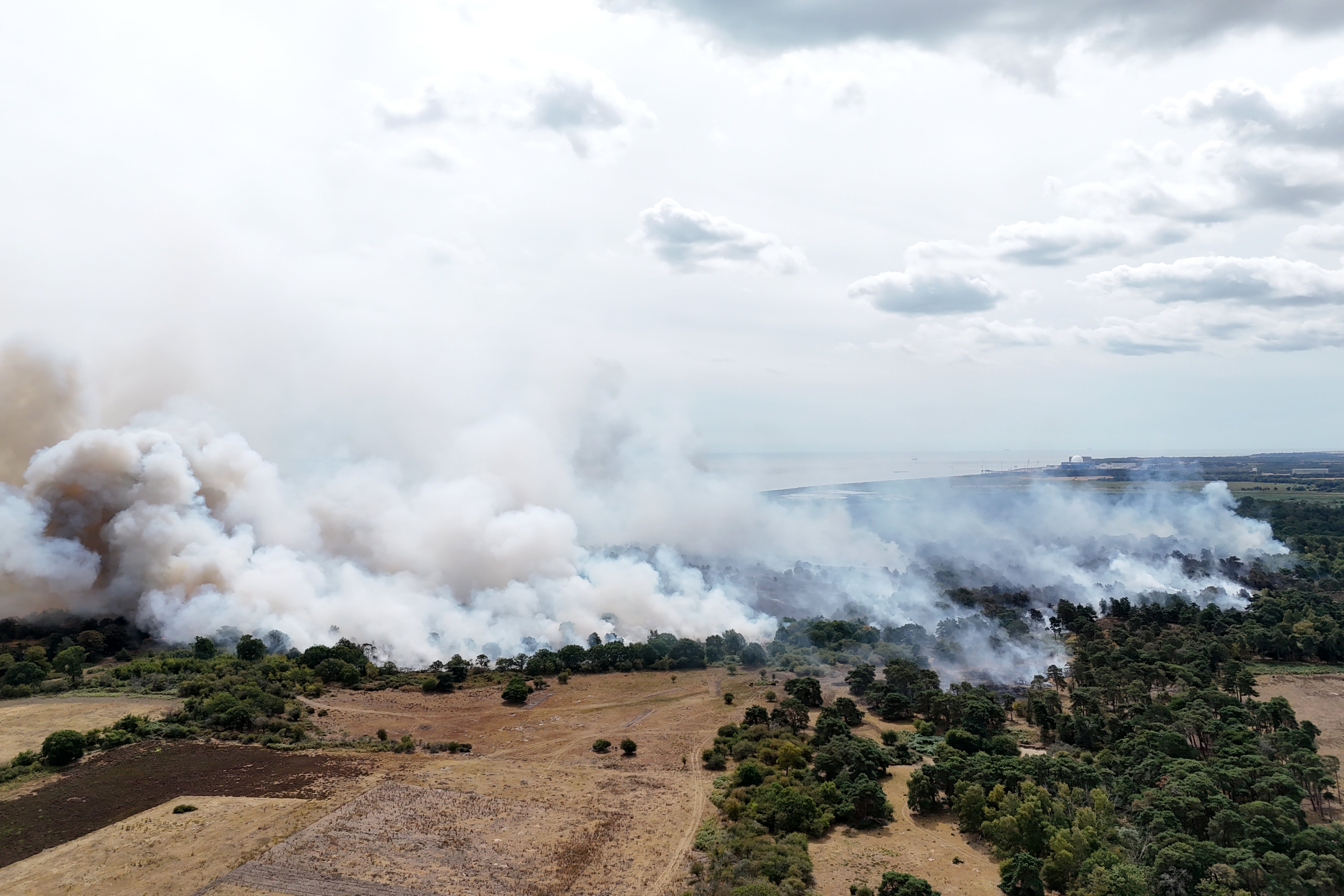 Pictures show smoke covering scorched fields