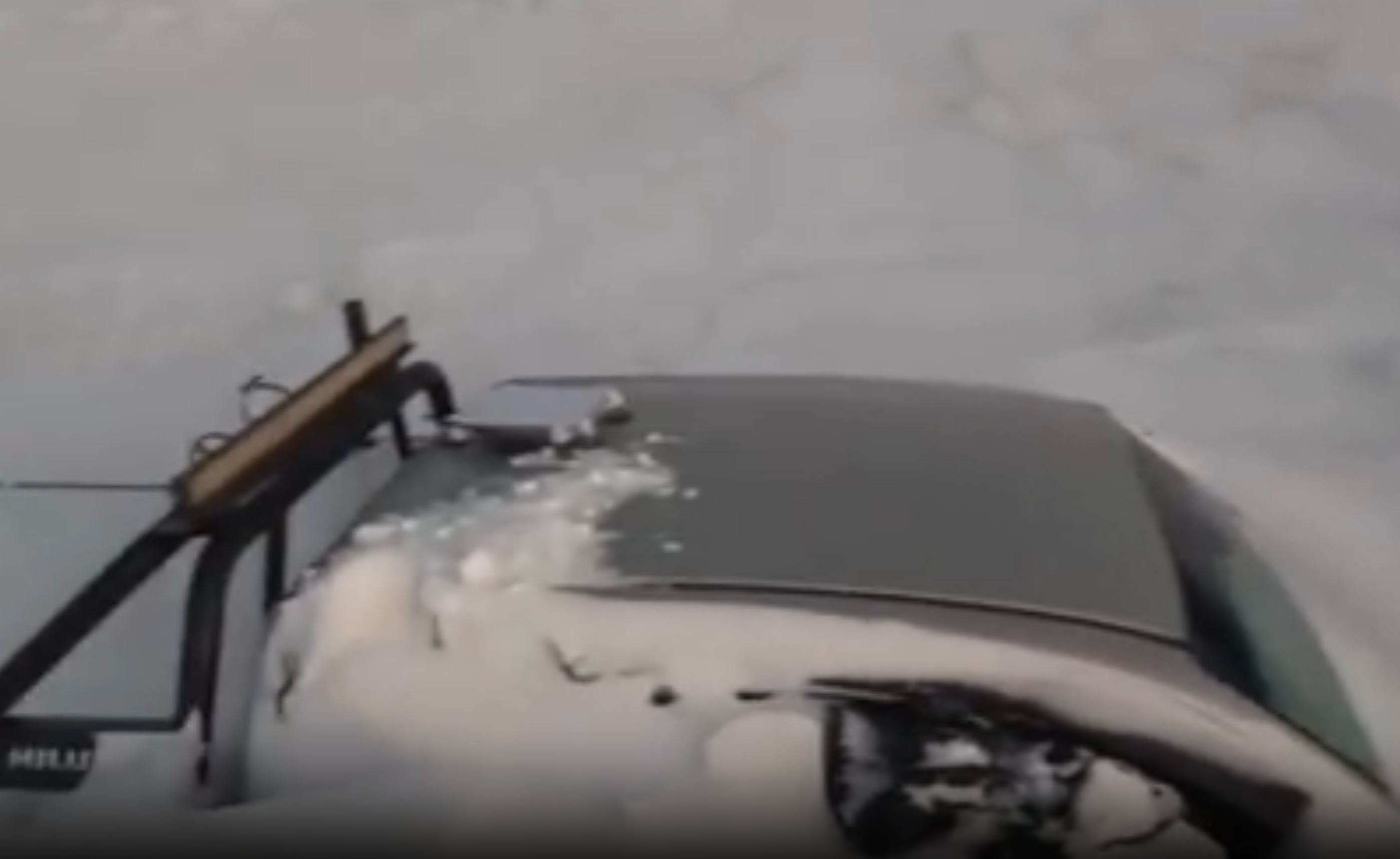 One of the pick-up trucks half-buried by the snowstorm