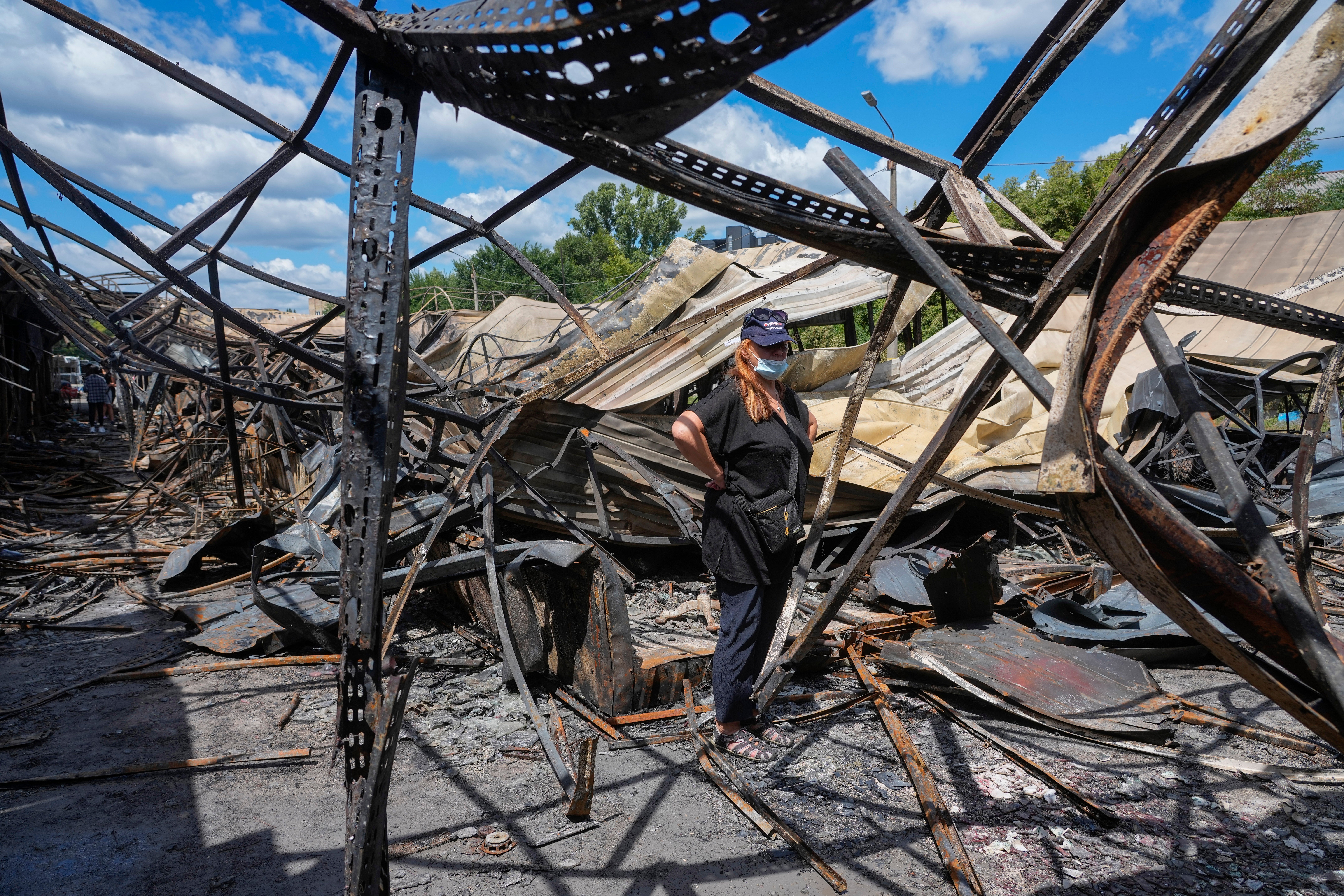 A market stall owner looks at the ruins following Russia's Thursday offensive (AP)