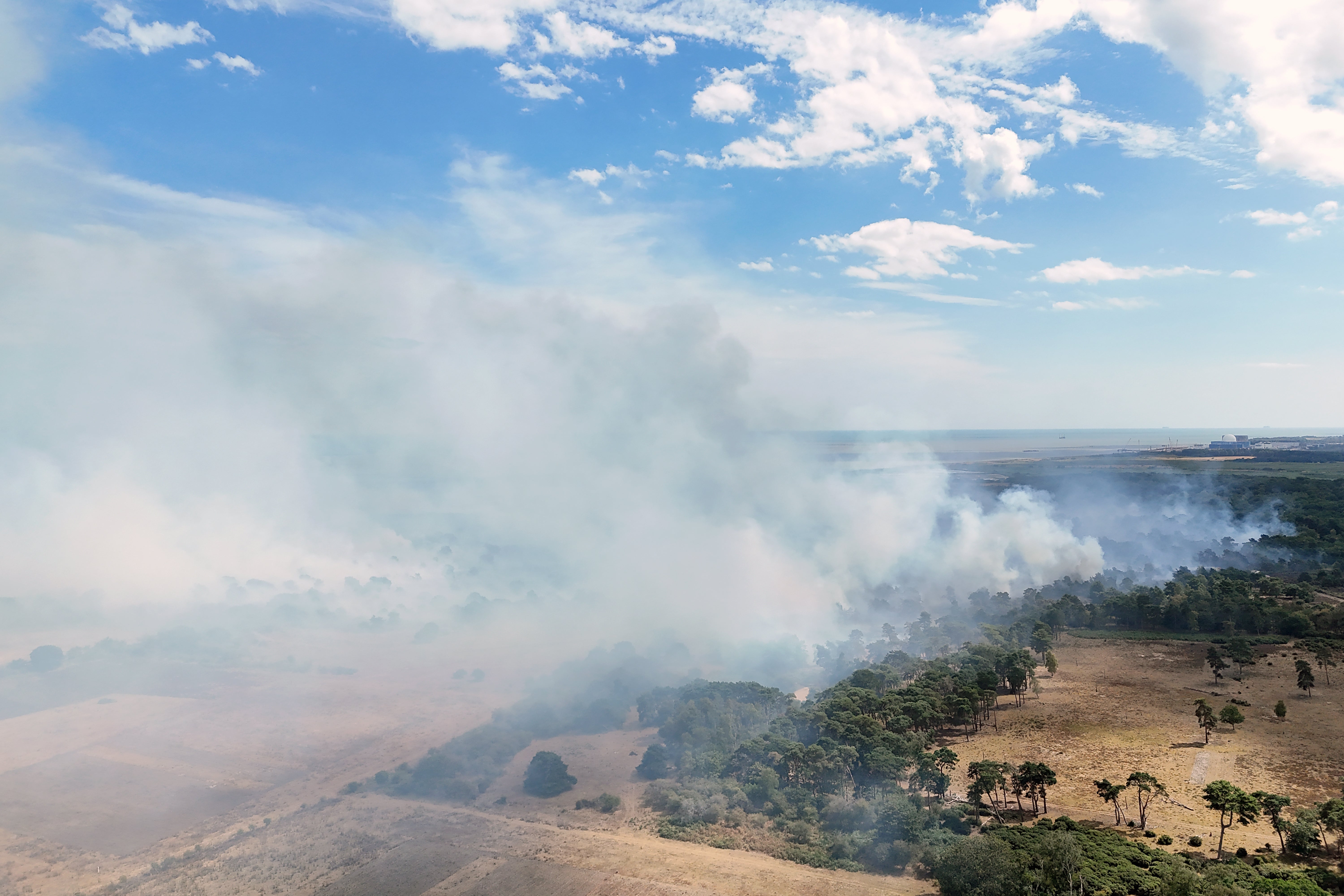 Smoke rises from the fire amid parched land (PA)