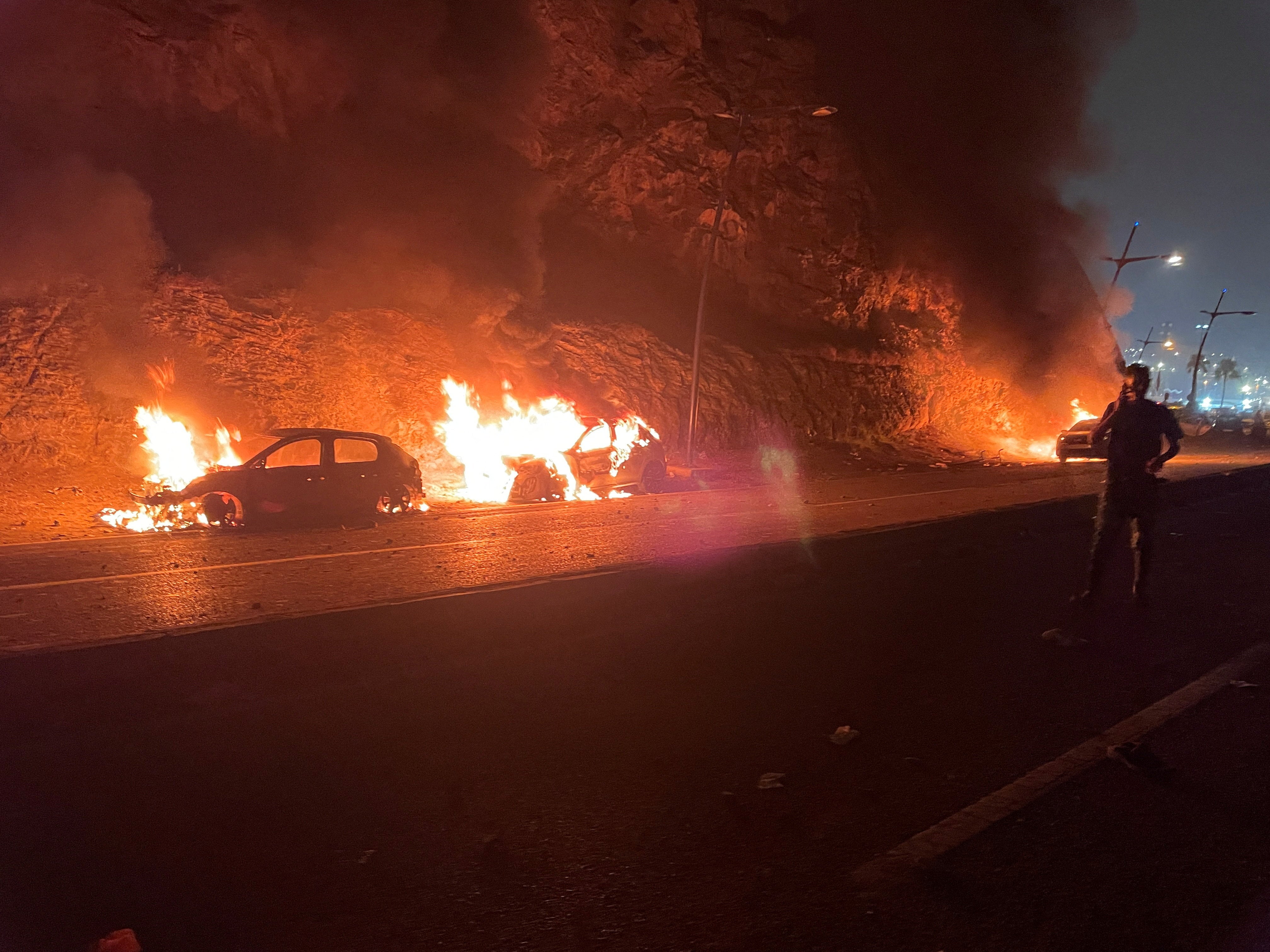Vehicles burn in Fnideq, Morocco, July 31, 2026, as migrants (not pictured) wait for a chance to cross to the Spanish enclave of Ceuta. Picture taken with a mobile phone. REUTERS/Ahmed El Jechtimi