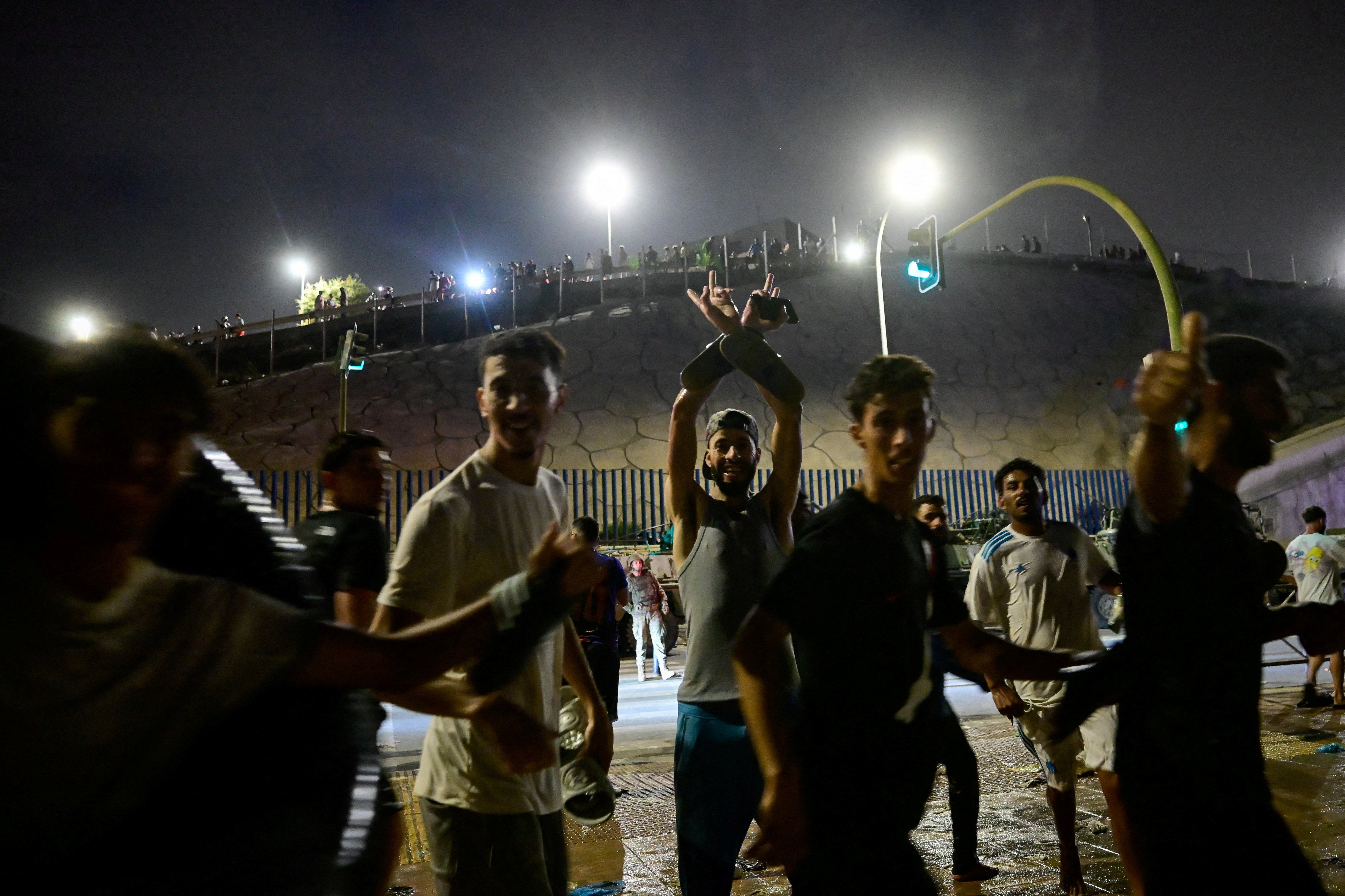 Migrants from Morocco react as they crossed into Ceuta by sea, at the border between the Spanish enclave of Ceuta and Morocco, as seen from Ceuta, Spain, July 30, 2026