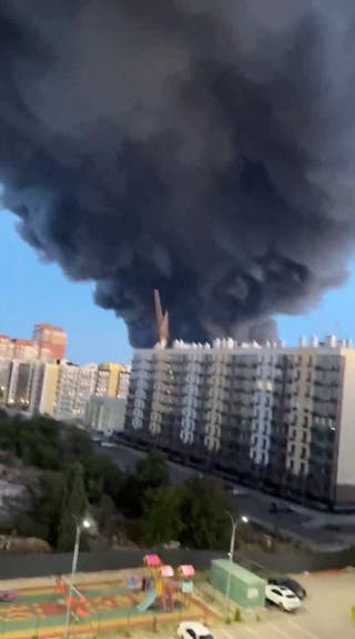 Smoke billows into the sky from the direction of a building hit during Ukraine's strikes in Volgograd on Friday