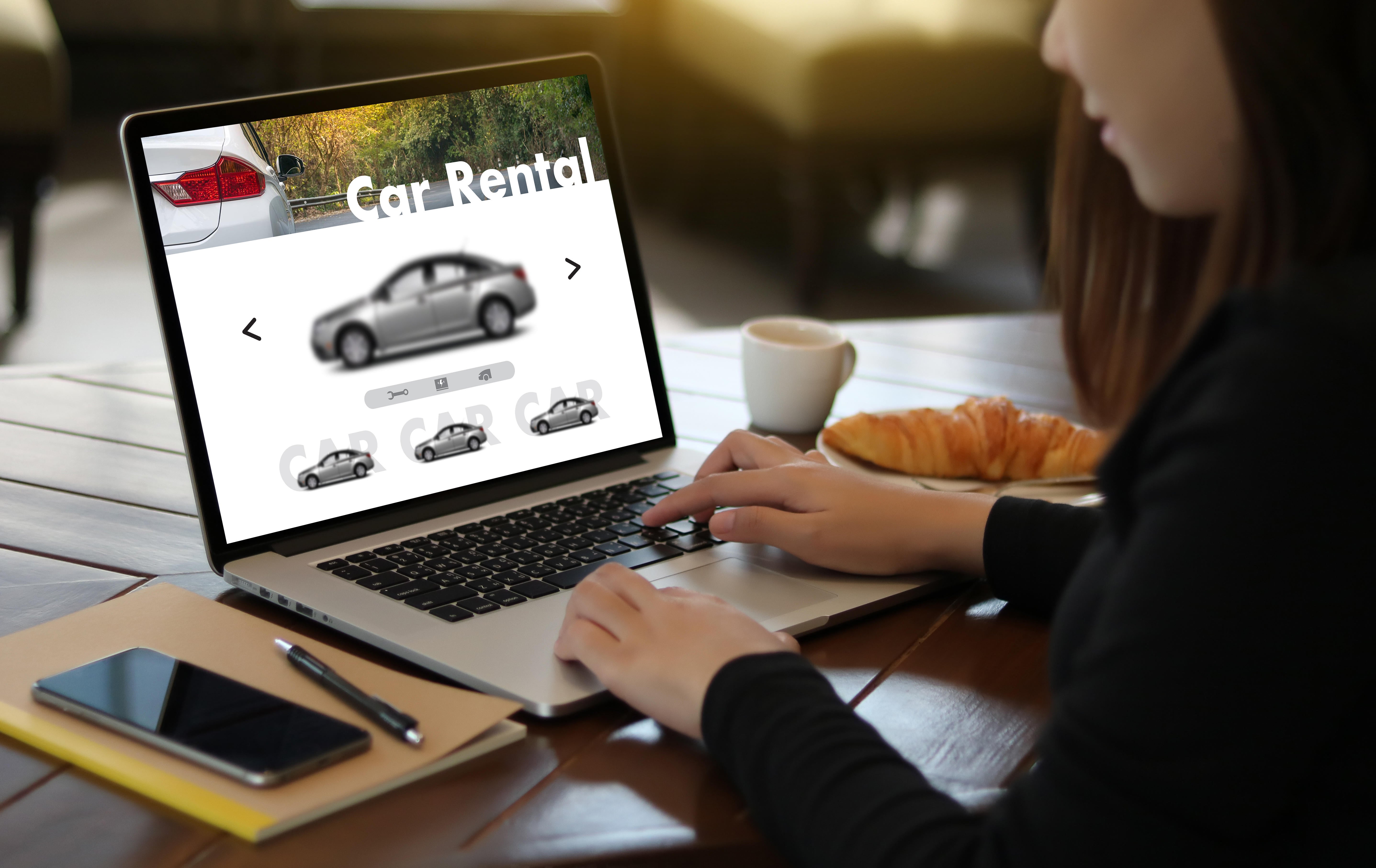 Woman looking at a car rental website (Alamy/PA)