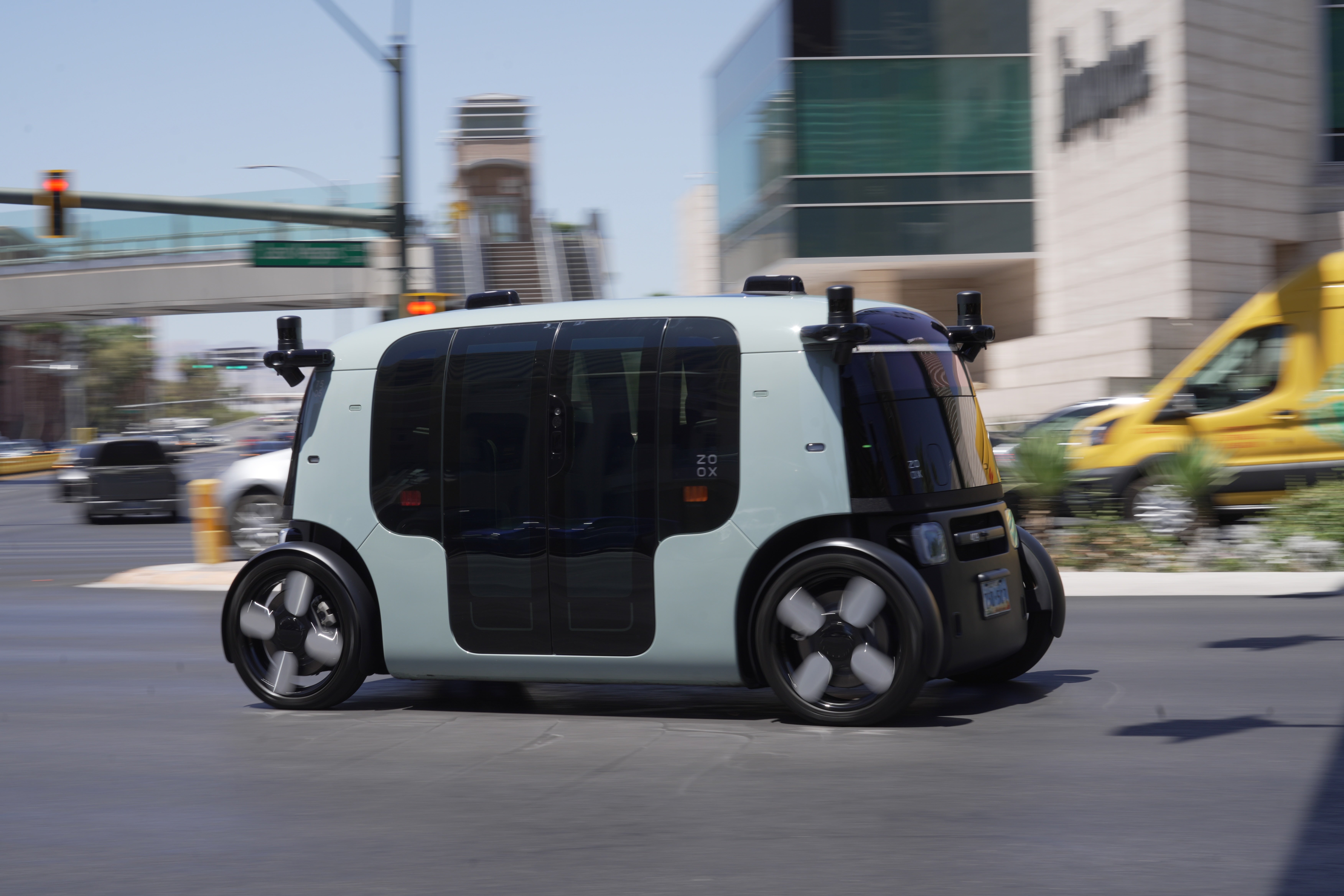 A Zoox taxi with no steering wheel drives down the Las Vegas strip on Thursday, July 30 (AP)