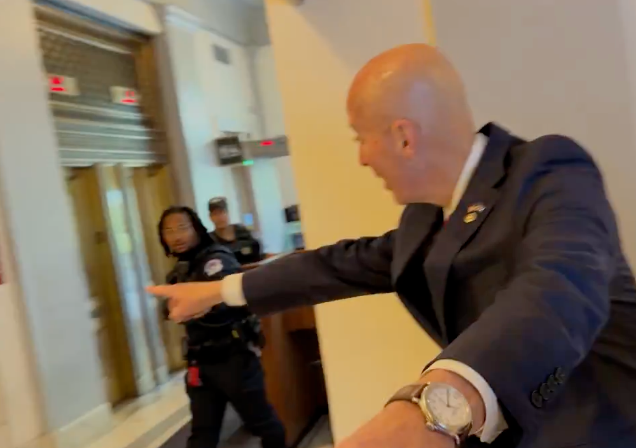 Nebraska Republican Sen. Pete Ricketts attracts the attention of Capitol Police while walking away from a reporter