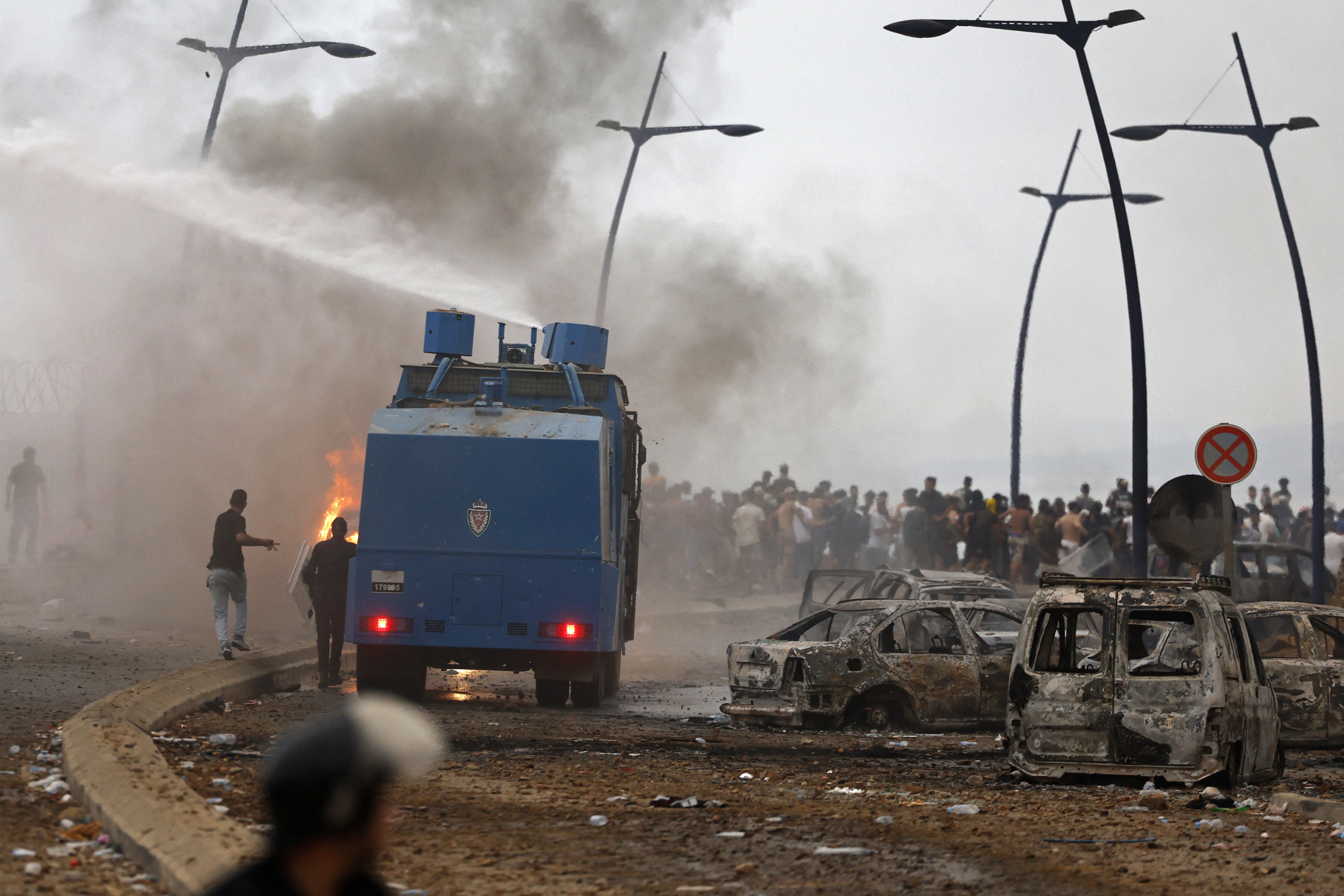 Moroccan security forces use water canon to disperse the crowds at the site of clashes near Fnideq (AFP/Getty)