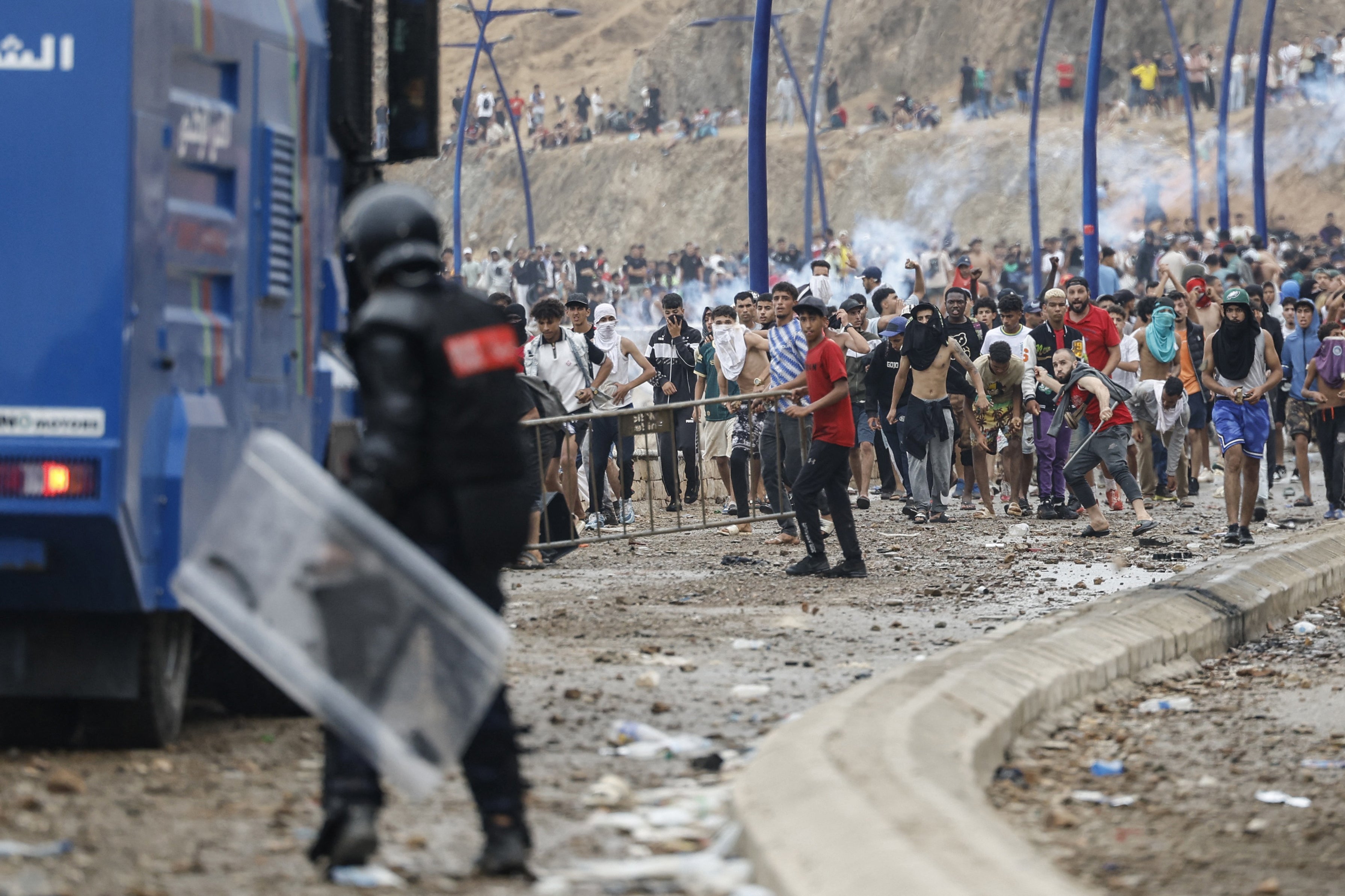 Moroccan security forces clash with migrants attempting to cross into Spain's North African enclave of Ceuta near the town of Fnideq (Photo by Abdel Majid BZIOUAT / AFP via Getty Images)