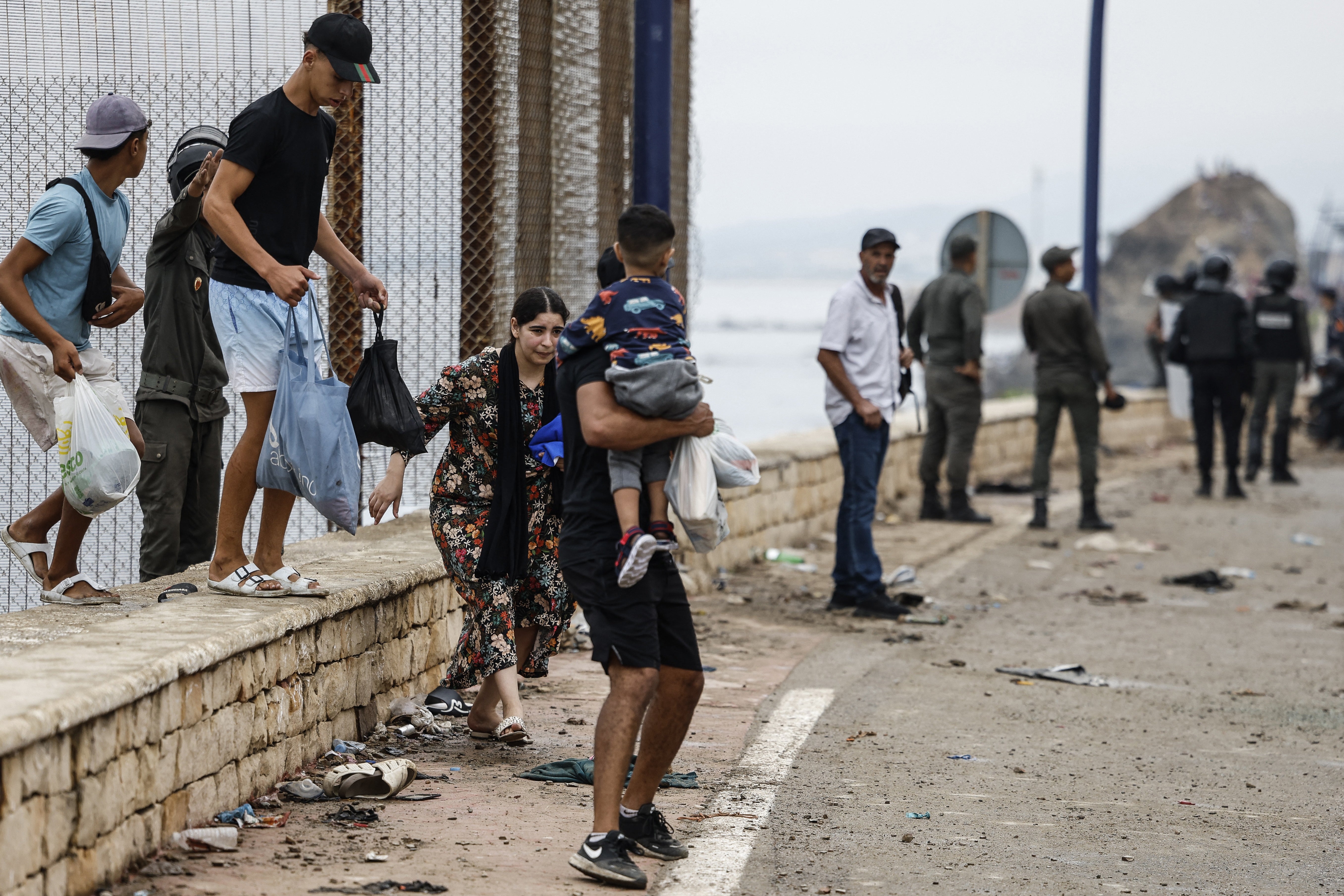 A woman reacts during clashes between Moroccan security forces and migrants (Photo by Abdel Majid BZIOUAT / AFP via Getty Images)