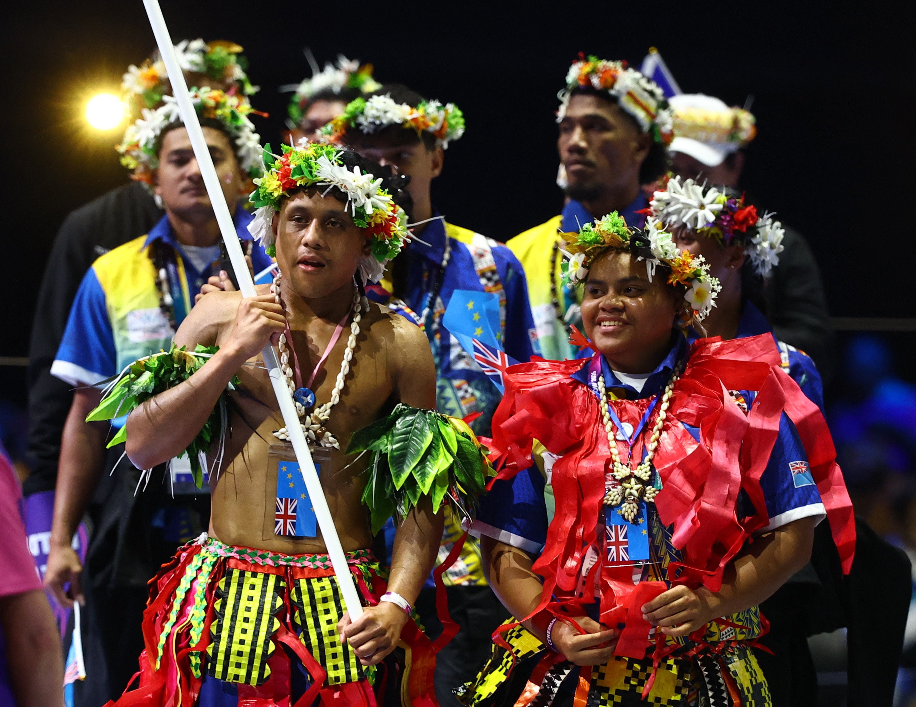 Siblings Tarona and Pasoni Taafaki lead athletes of Tuvalu during the opening ceremony