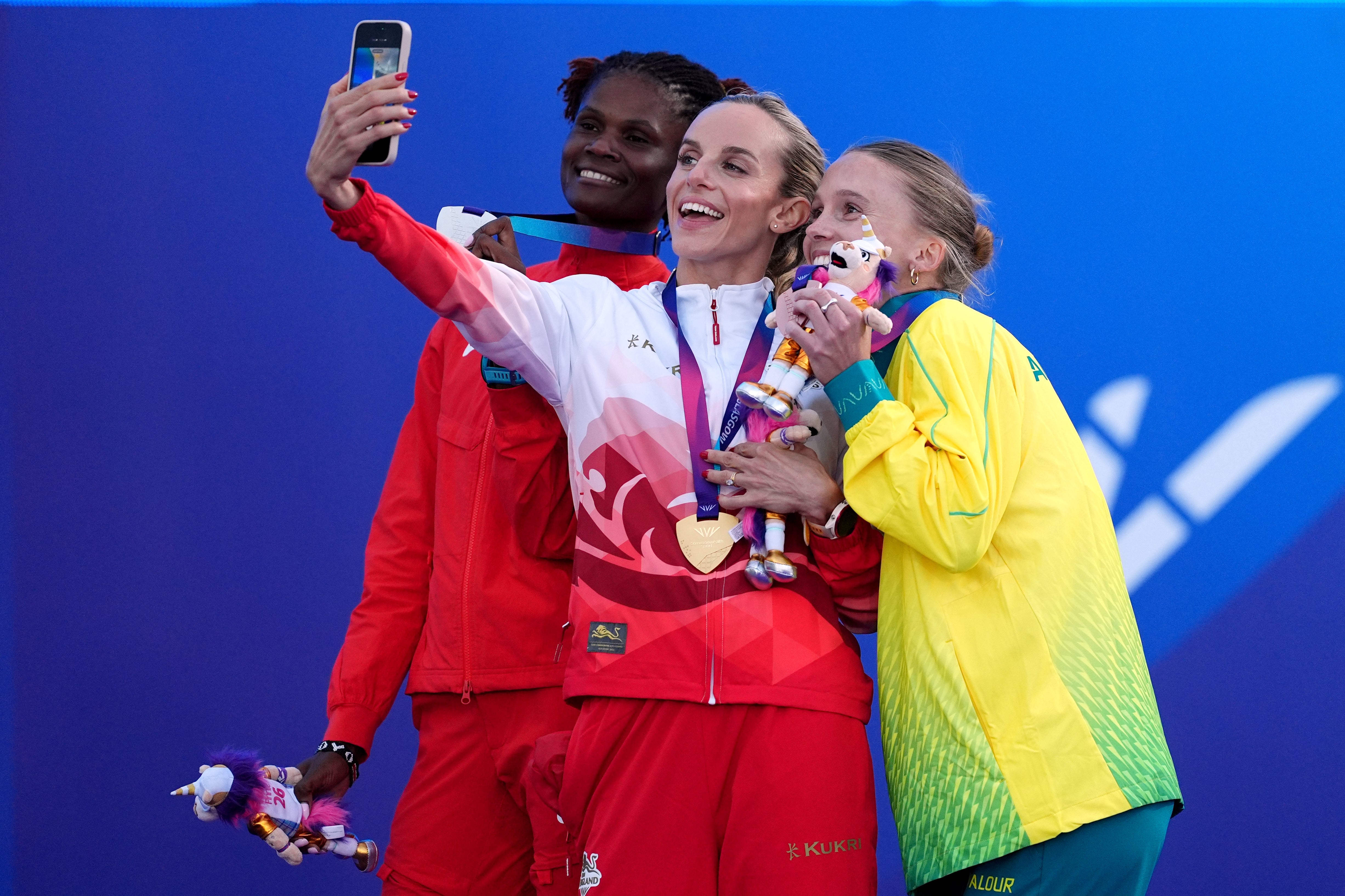 Hunter Bell, centre, celebrates with runner-up Lilian Odira and bronze medallist Sarah Billings (Martin Rickett/PA)
