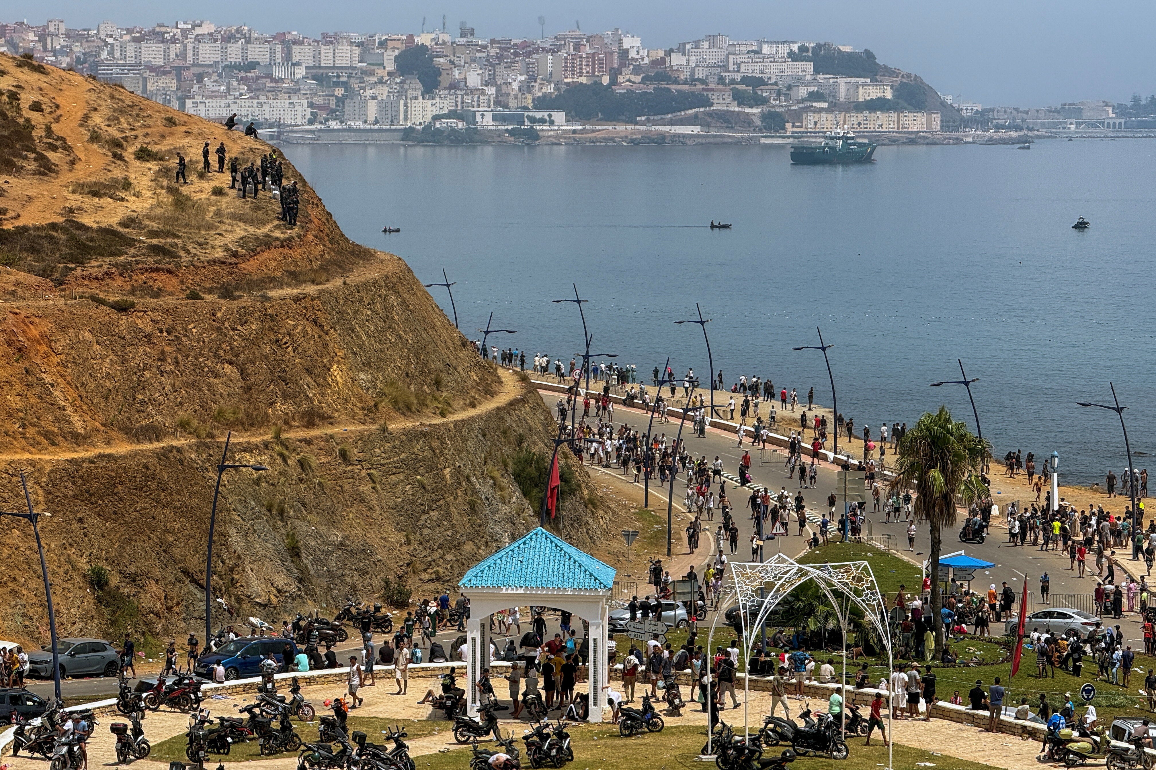 Migrants gather in Fnideq after crossing back from the Spanish enclave of Ceuta