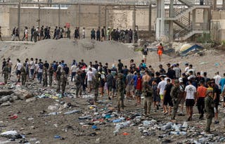 People walk towards the border with Morocco leaving Spain, amid mass crossings of migrants on foot and by sea from Morocco into Spanish territory, in Ceuta