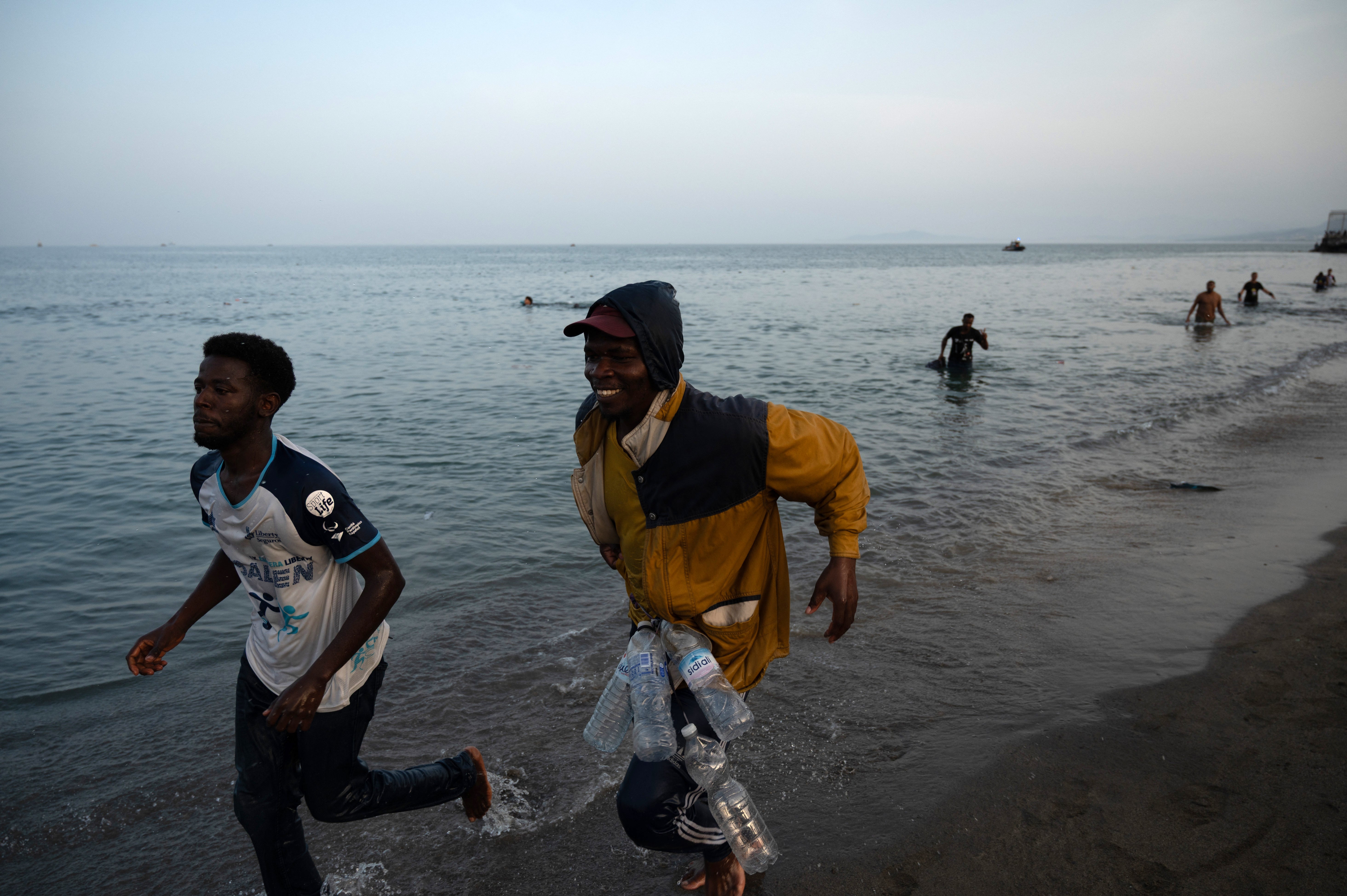 Migrants arrive on the shore after swimming into the Spanish enclave of Ceuta in North Africa (AFP/Getty)