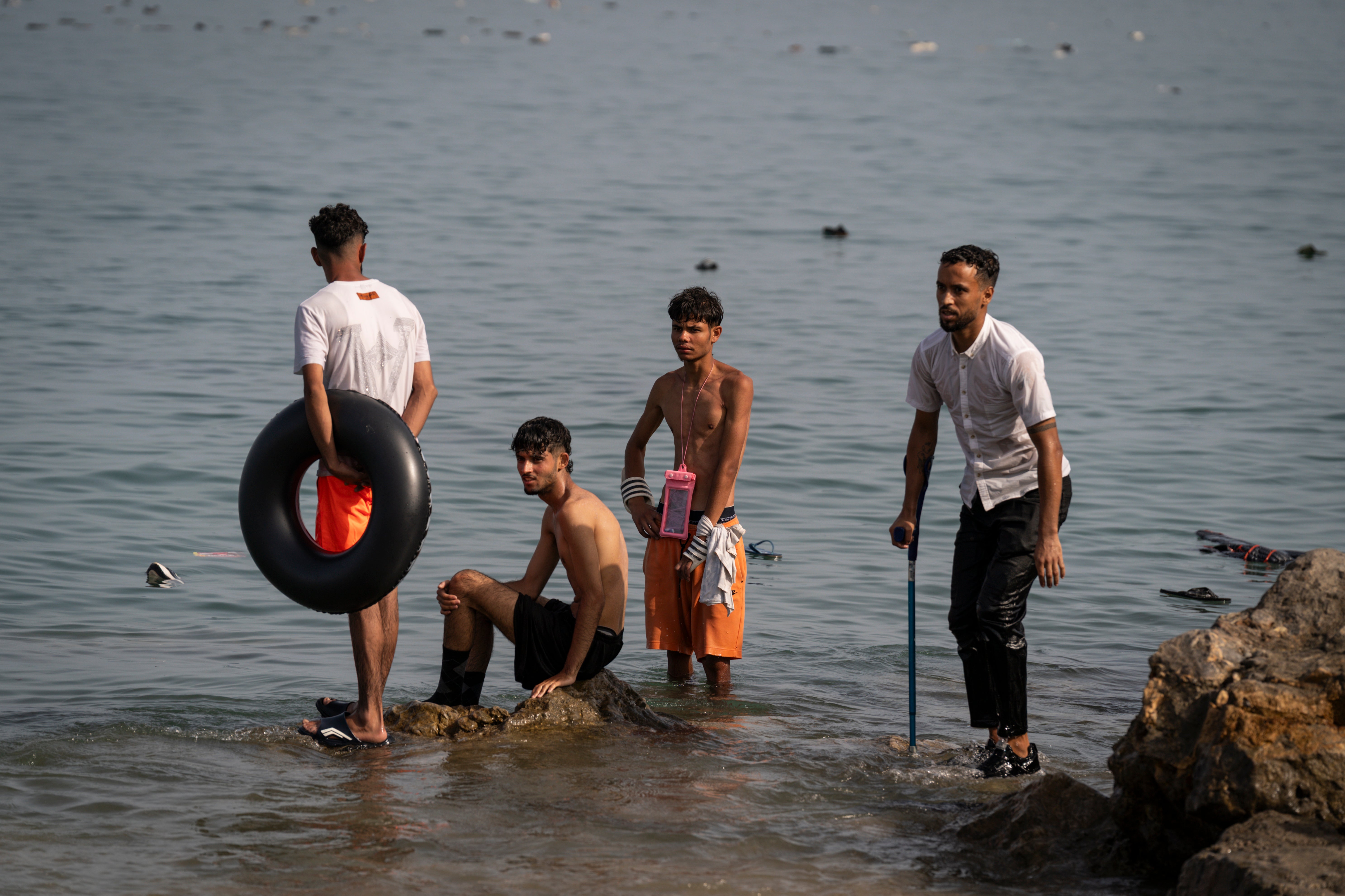 Migrants arrive on Tarajal beach after crossing the border between Spain and Morocco