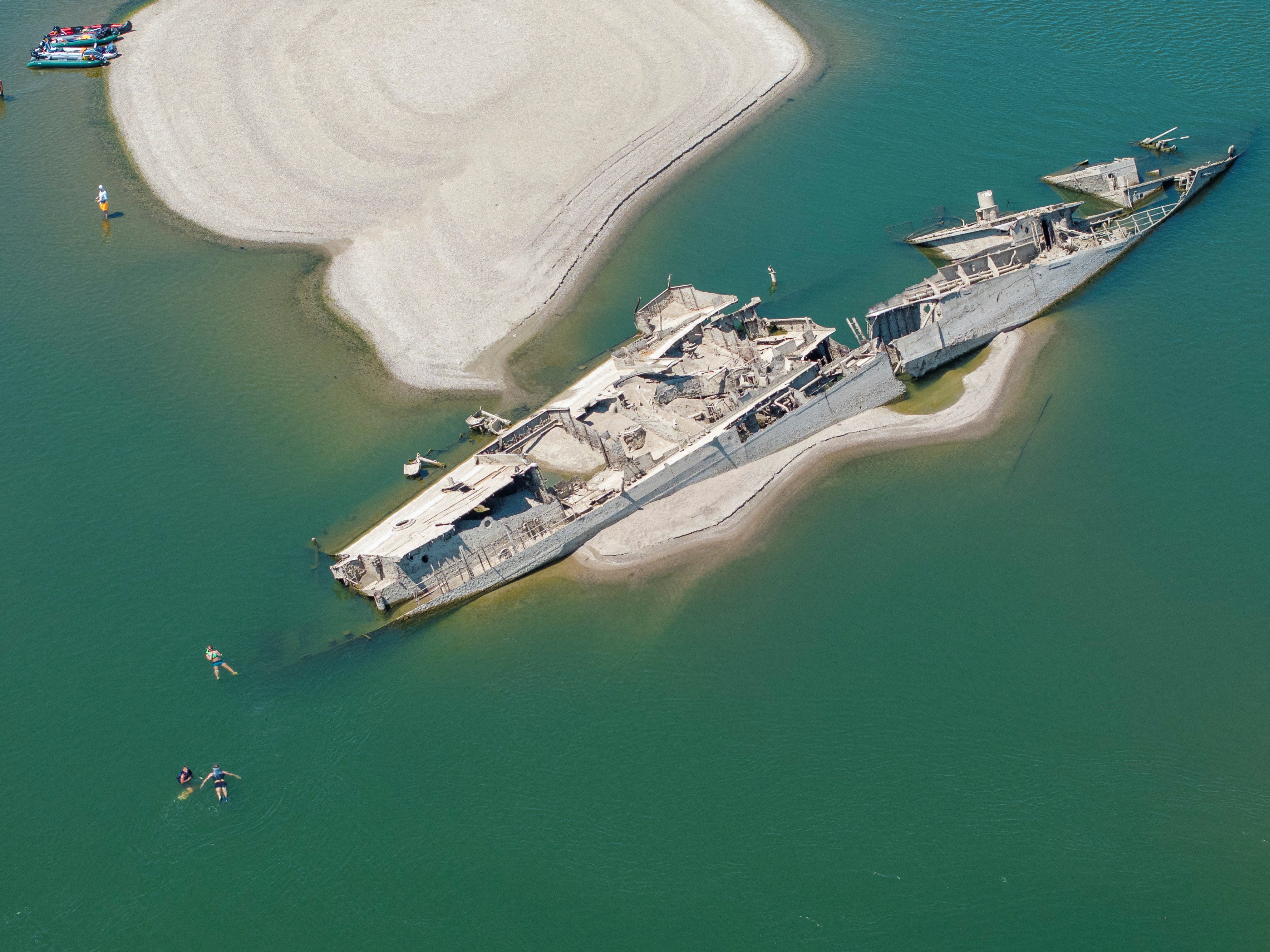 One German warship from World War II was exposed on the riverbed of the Danube in Prahovo, Serbia, as locals swam nearby to cool off in the heatwave