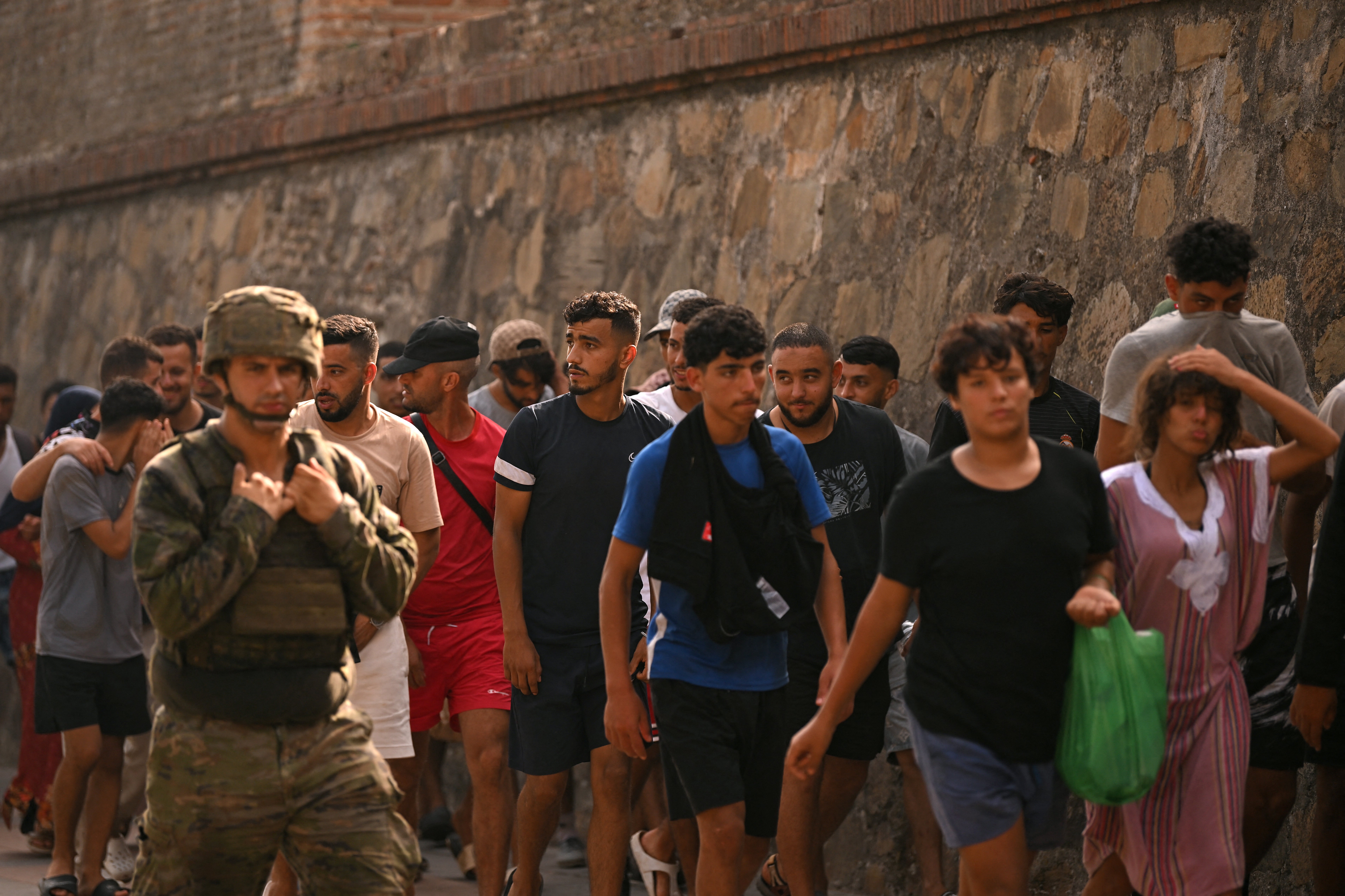 A Spanish soldier escorting migrants to the Moroccan border (AFP/Getty)