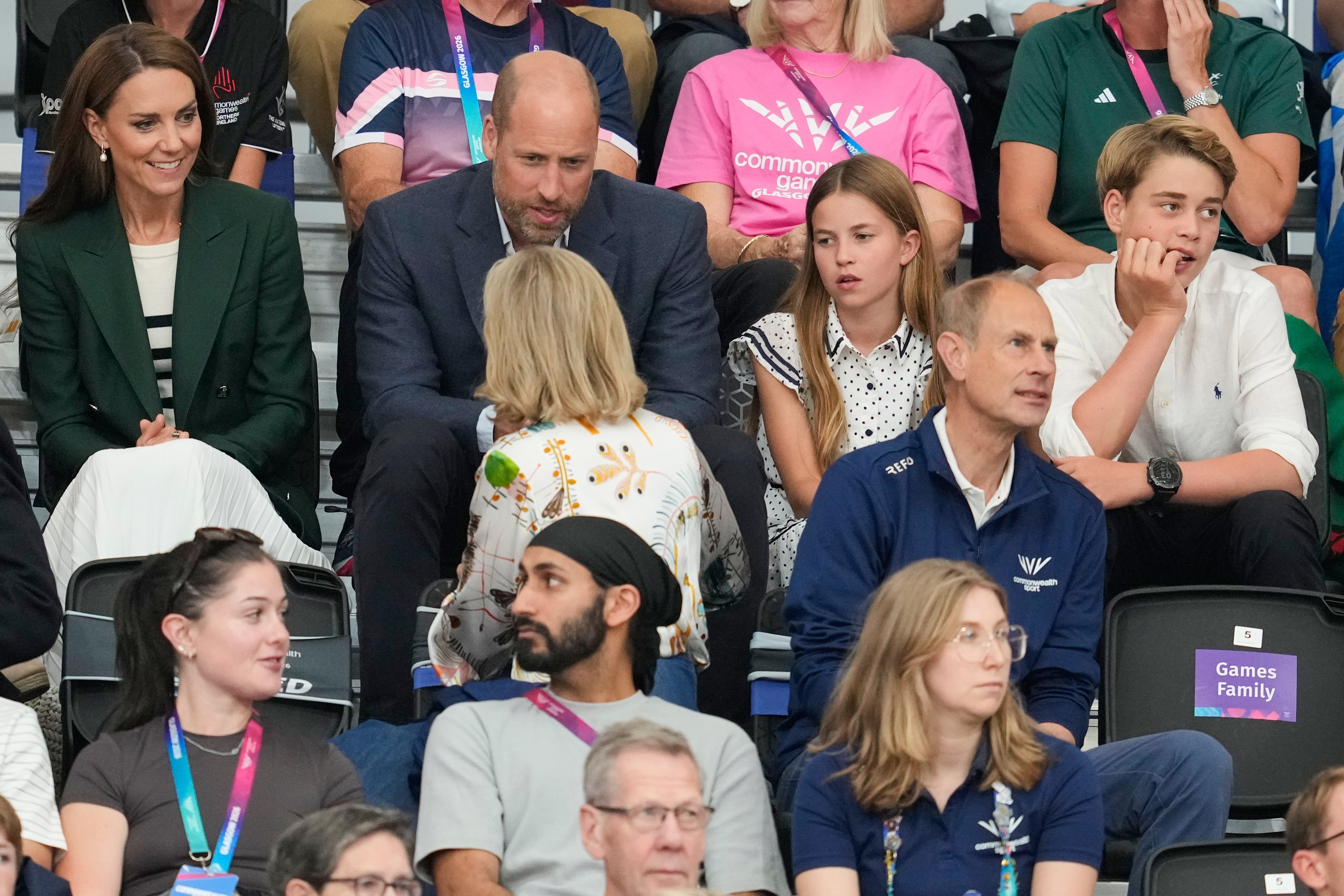 Kate, Princess of Wales, and William, Prince of Wales speak with Sophie, Duchess of Edinburgh as they sit with their children Princess Charlotte and Prince George in the audience to watch the track cycling
