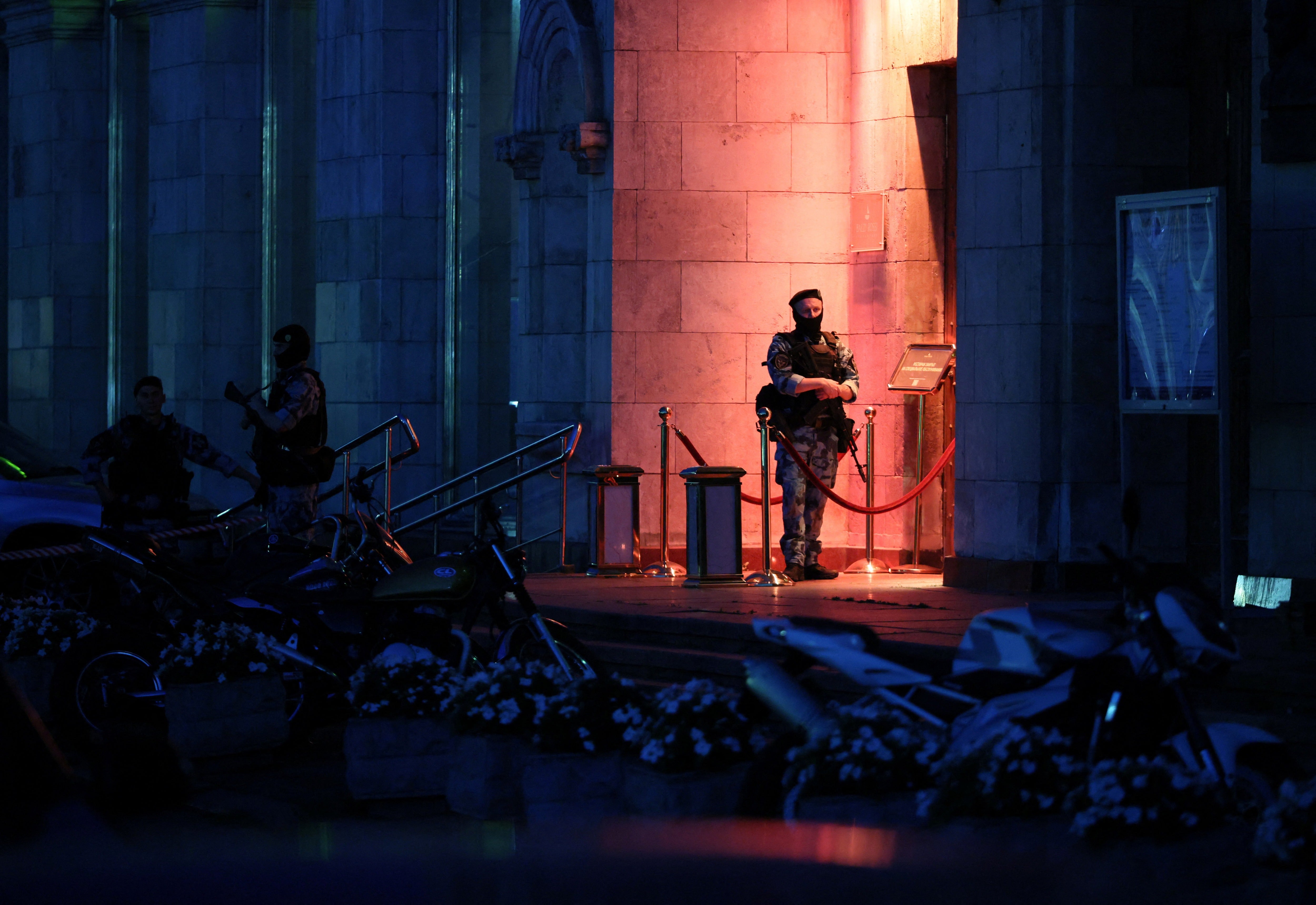 Law enforcement officers stand guard at the site of an explosion at a restaurant in central Moscow