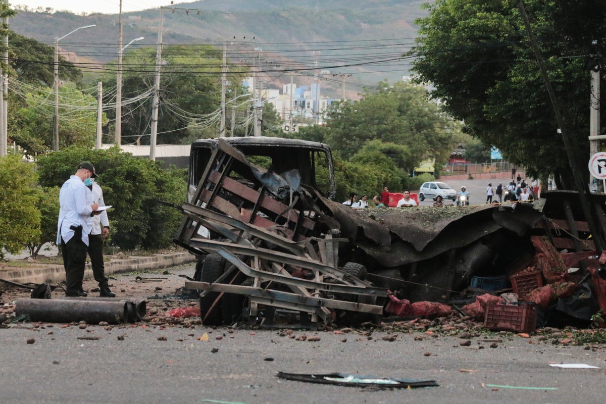 Truck explodes outside Colombia police base, injuring 11 officers and killing a dog Truck explodes outside Colombia police base, injuring 11 officers and killing a dog