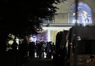 Law enforcement officers and emergency services personnel work at the site of an explosion at a restaurant in central Moscow