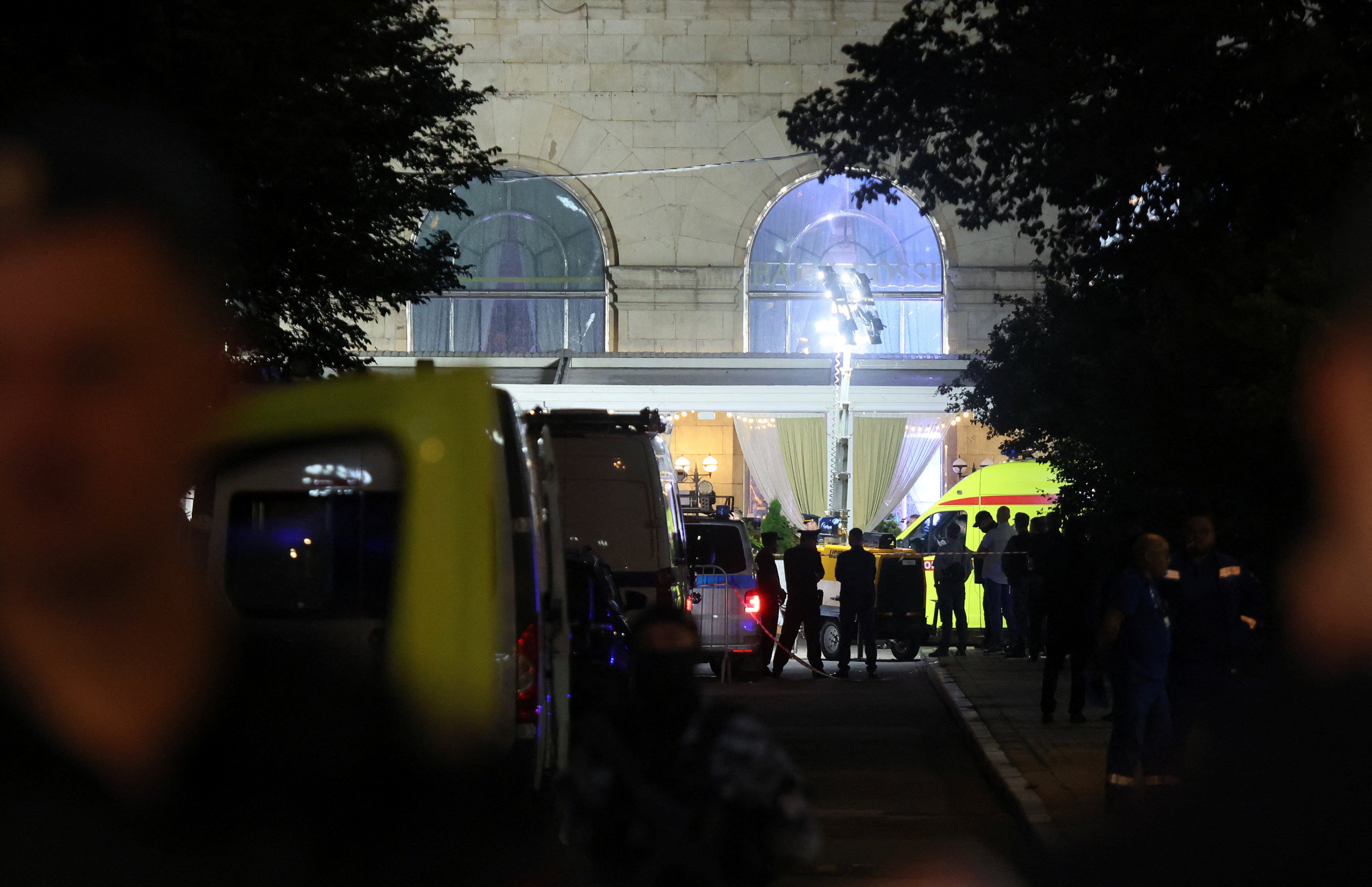 Law enforcement officers and emergency services personnel work at the site of an explosion at a restaurant in central Moscow