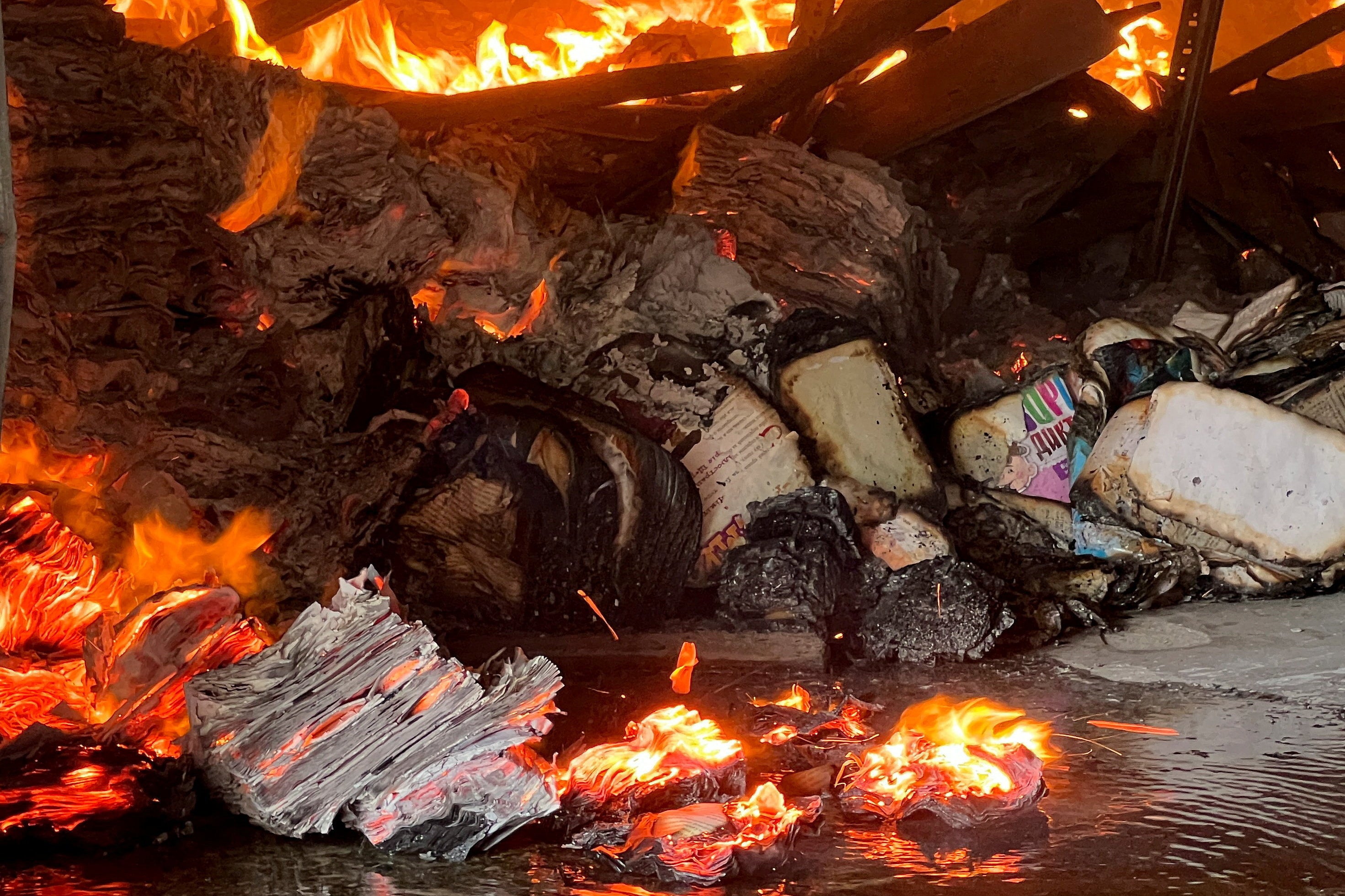 Books burn at the site of a book warehouse hit by a Russian drone strike in Kharkiv, Ukraine (Reuters)