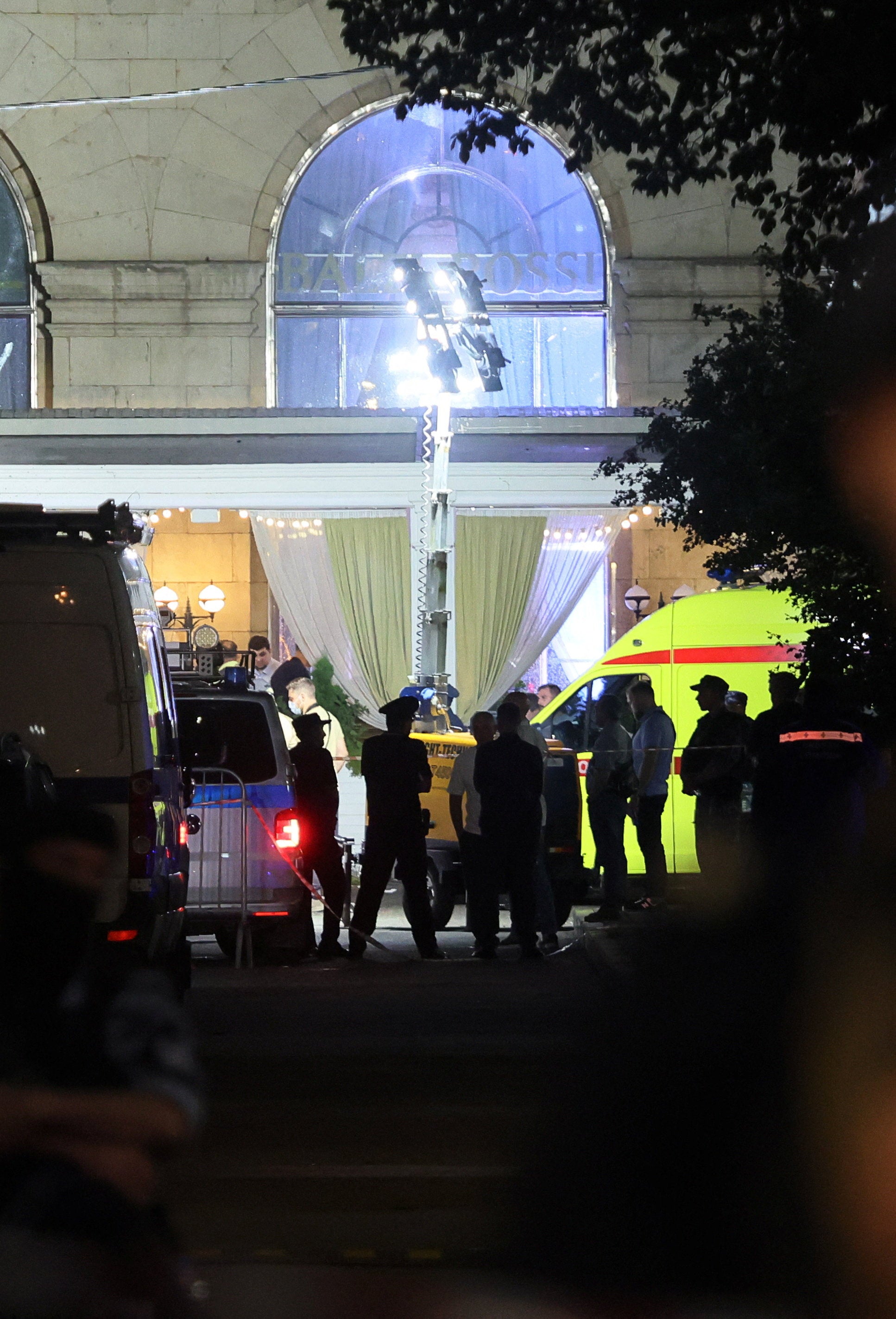 Law enforcement officers and emergency services personnel work at the site of an explosion at a restaurant in central Moscow, Russia