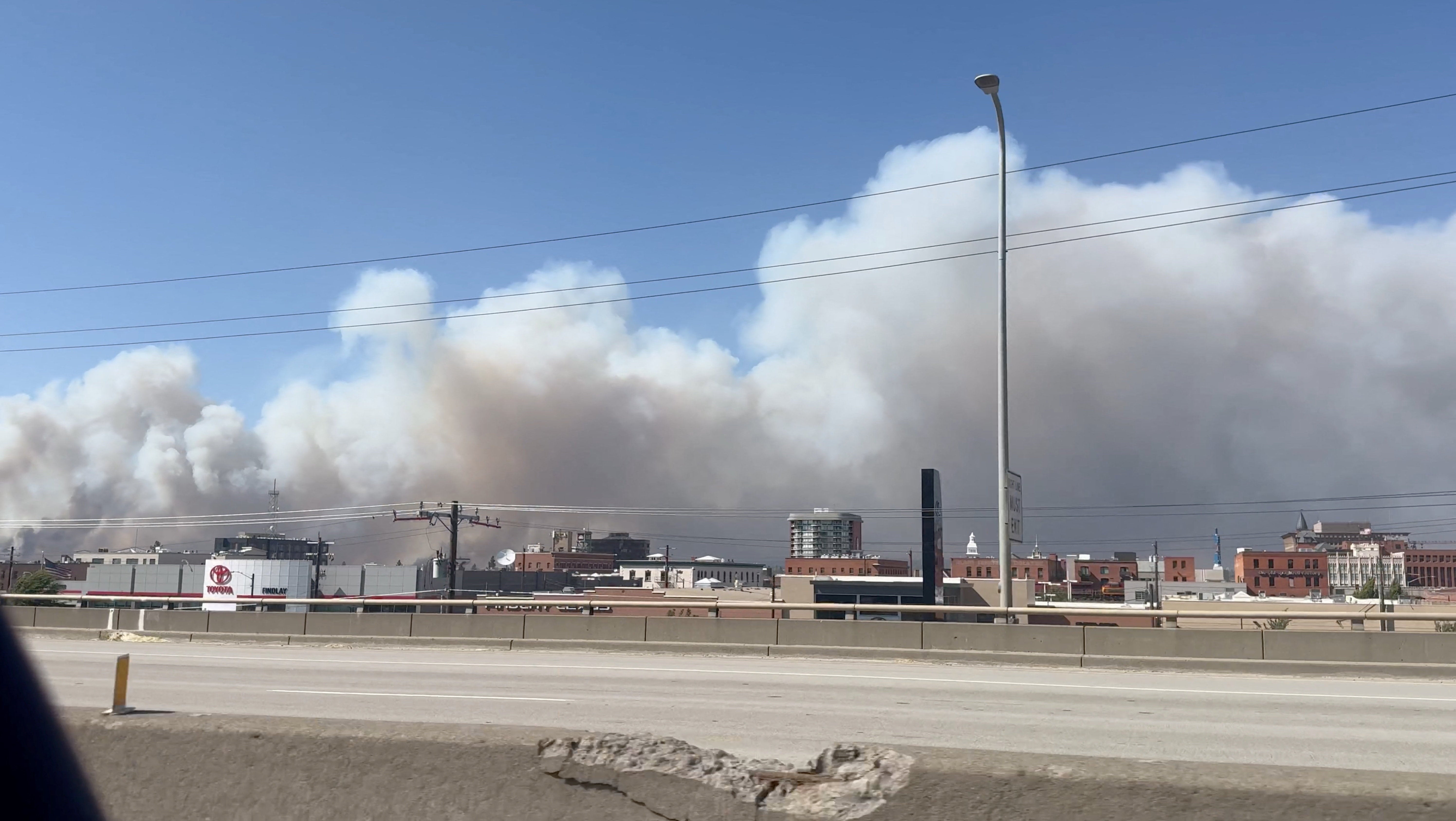 Residents flee fast-moving Washington wildfire as officials investigate what started it
