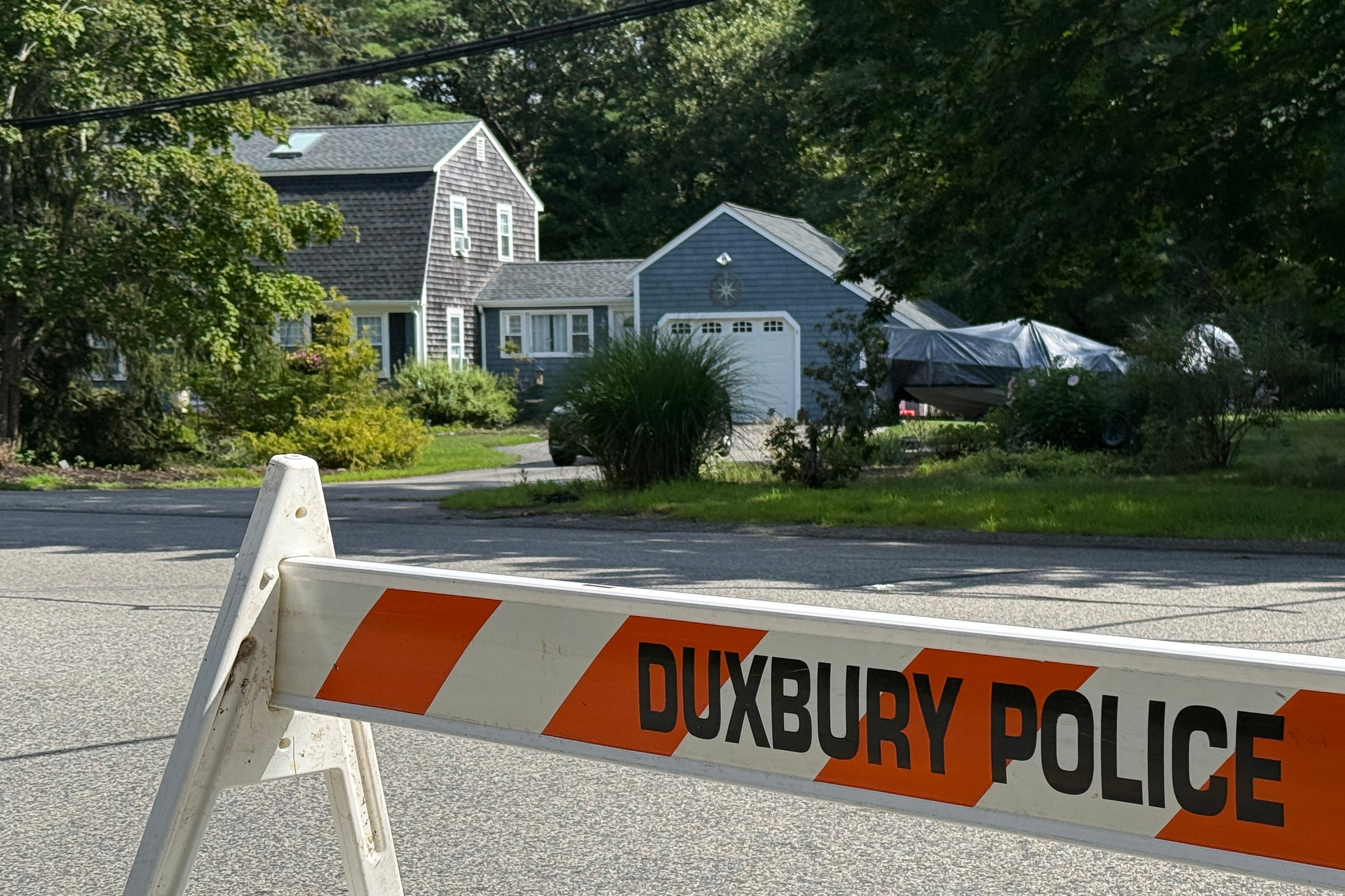 A police barricade stands outside the former home of Lindsay Clancy in Duxbury, Mass., on Friday, July 31, 2026