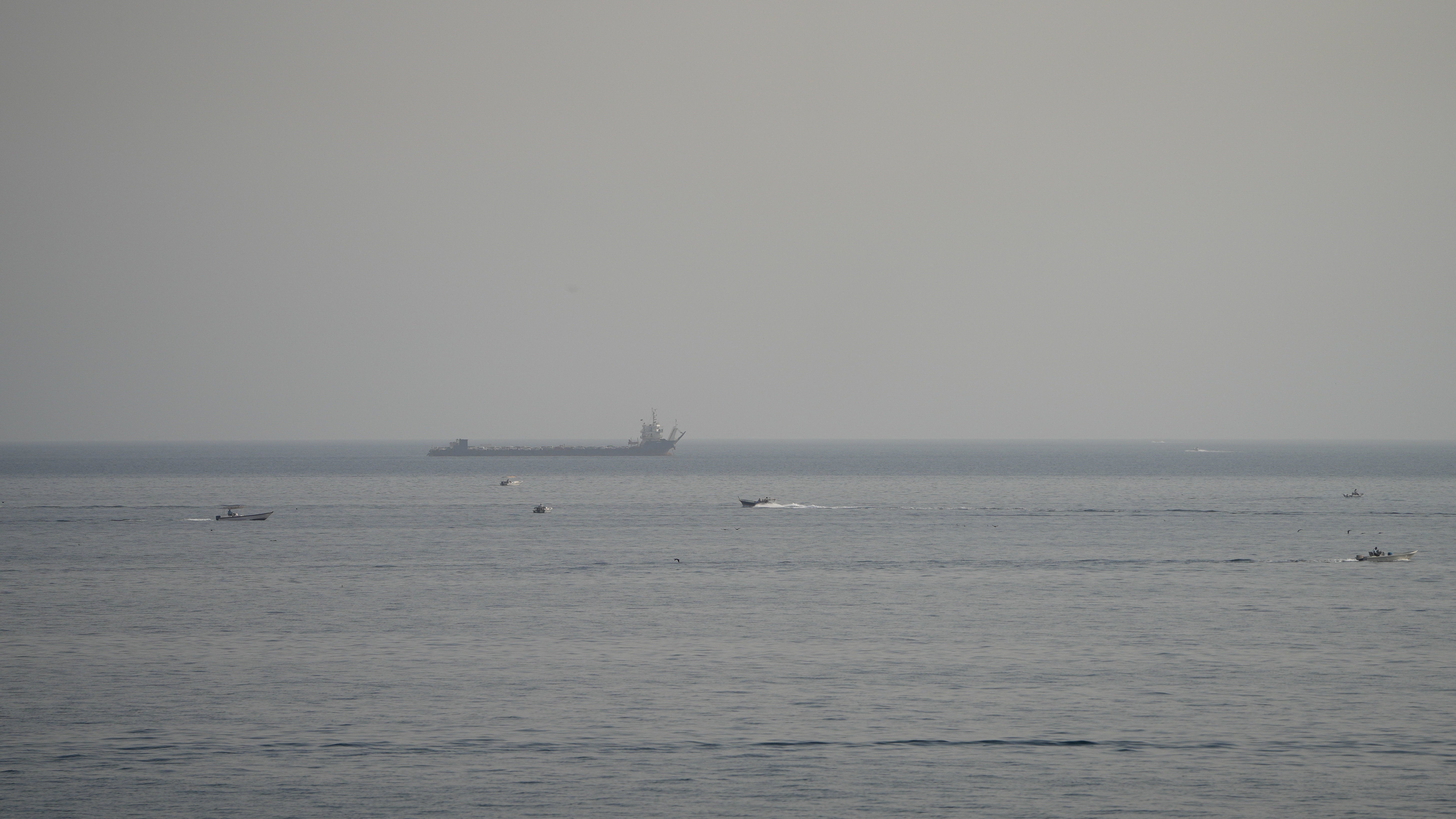 Boats and a vessel in the Strait of Hormuz, as seen from Musandam, Oman, August 3 (Reuters)