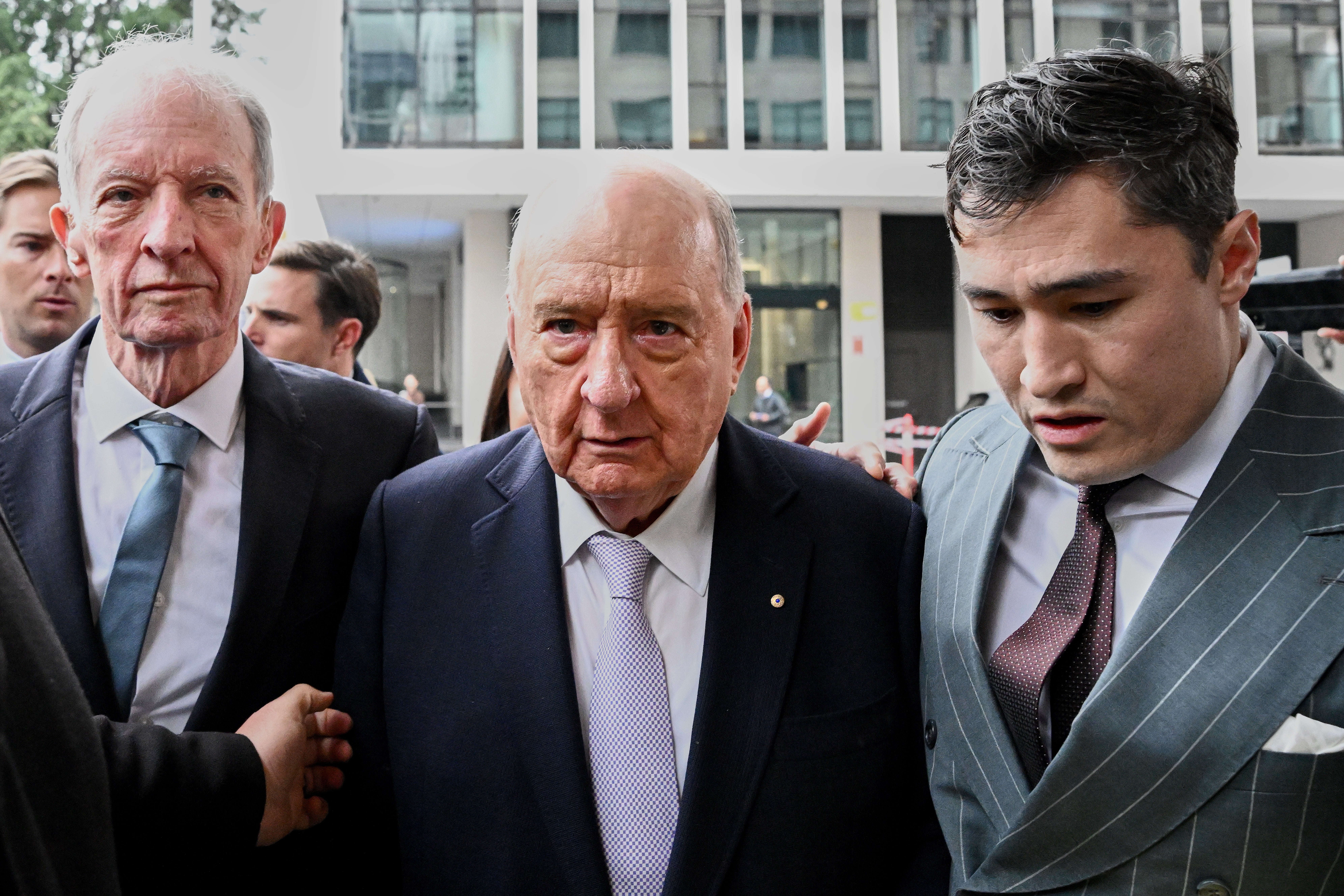 Alan Jones, centre, outside court on Monday