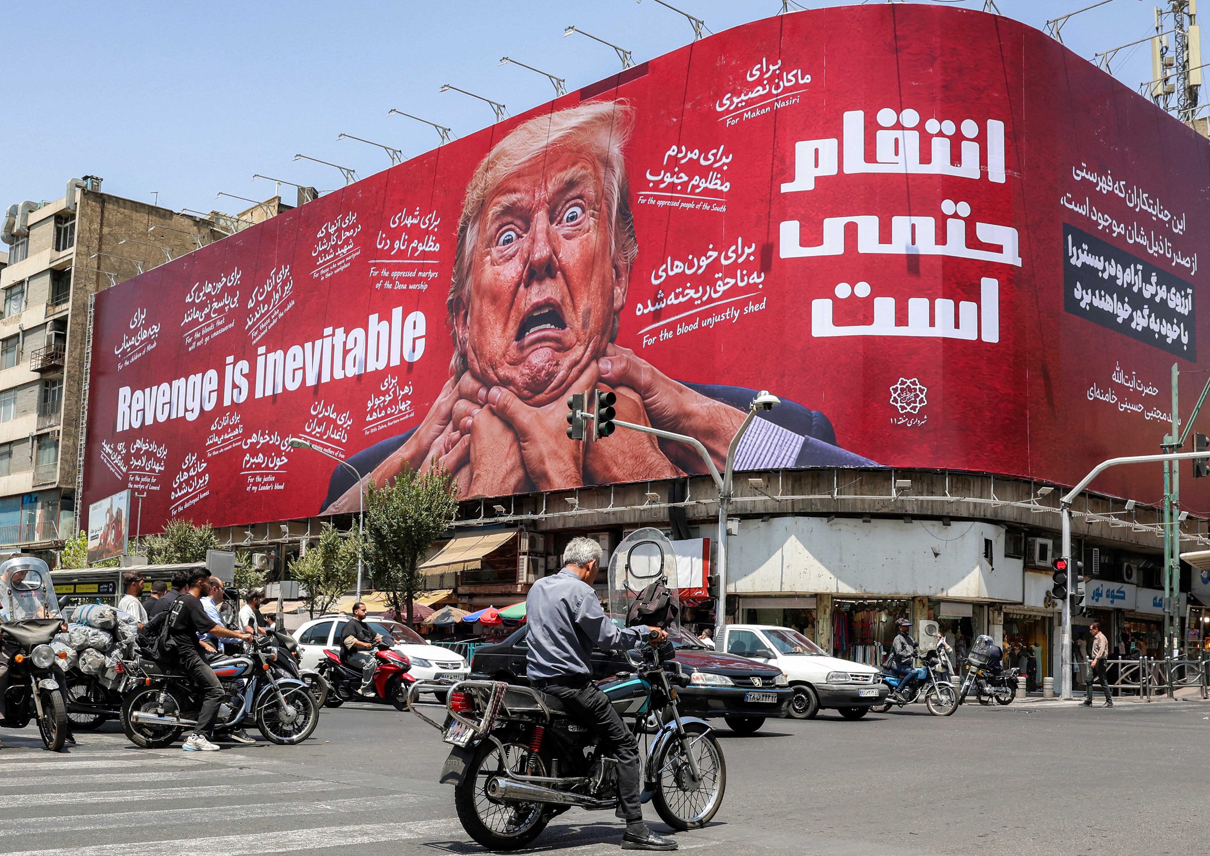Iran’s acting defense minister accused the US of 'psychological and cognitive warfare,' according to a state media post on X. Pictured: Motorists in Tehran drive past a large billboard pledging revenge against Trump on July 27