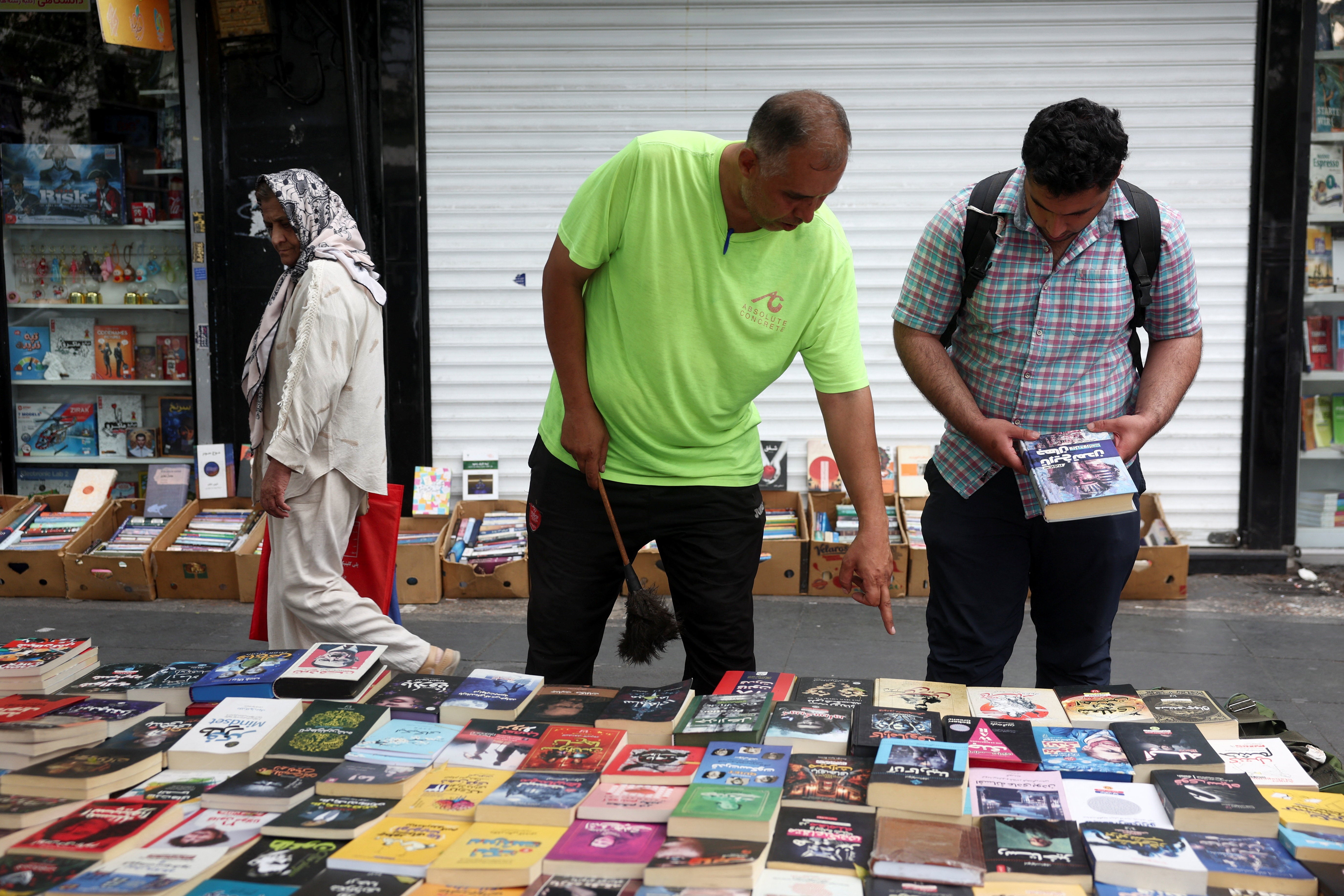 A person looks at books on a street in Tehran (Reuters)