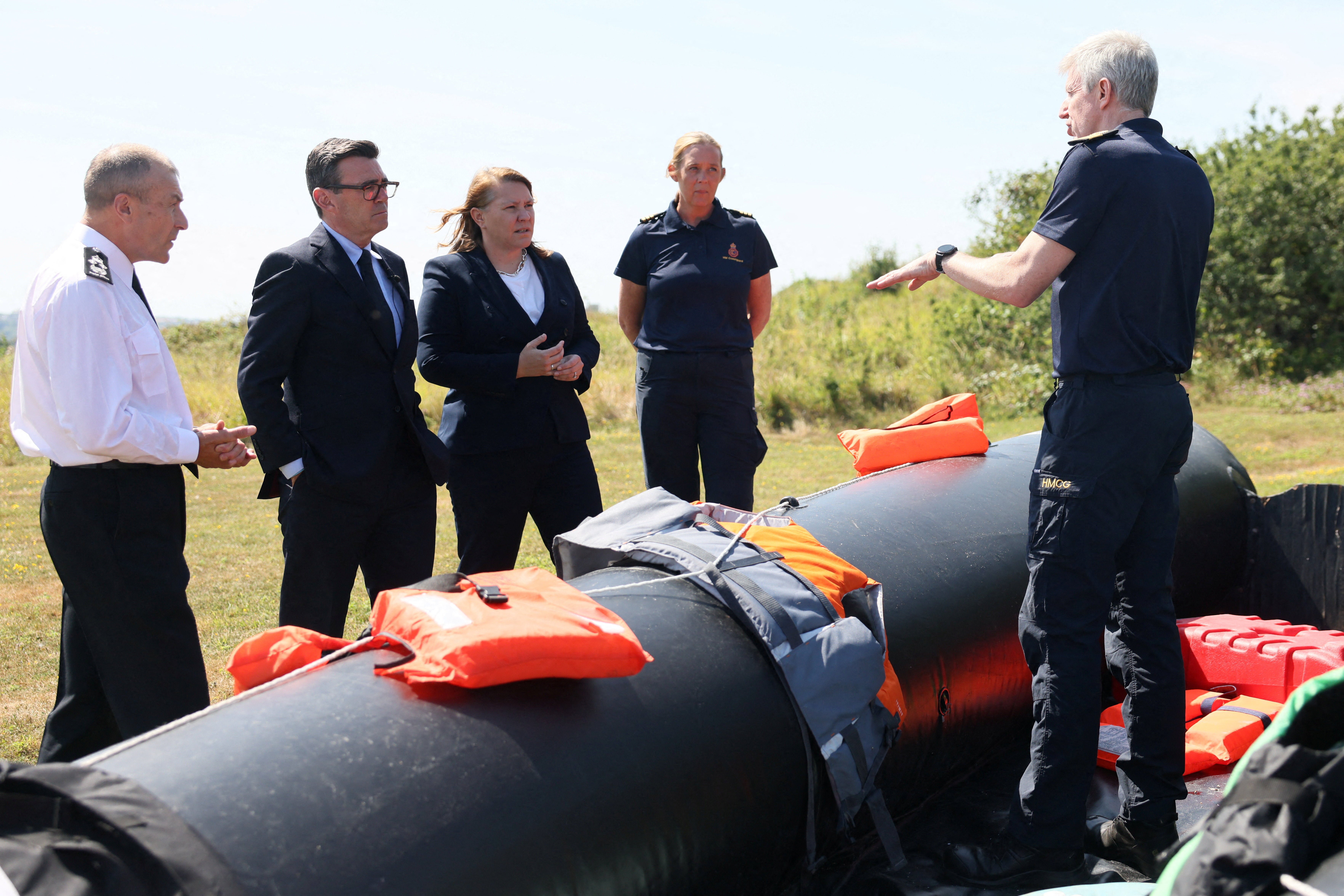 <p>Andy Burnham and Minister for Border Security and Asylum Anna Turley stand by a recovered small boat used by migrants crossing the English Channel</p>