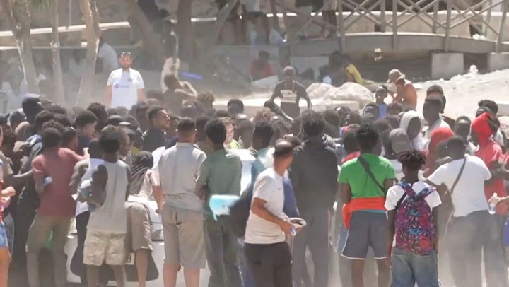 Migrants brawl over food and water aid in Ceuta after border surge