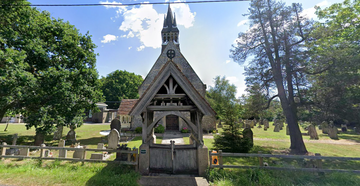 A lamb was placed on a tree stump with an inverted stone cross next to it at Christ’s Church in Colbury (Google Maps)