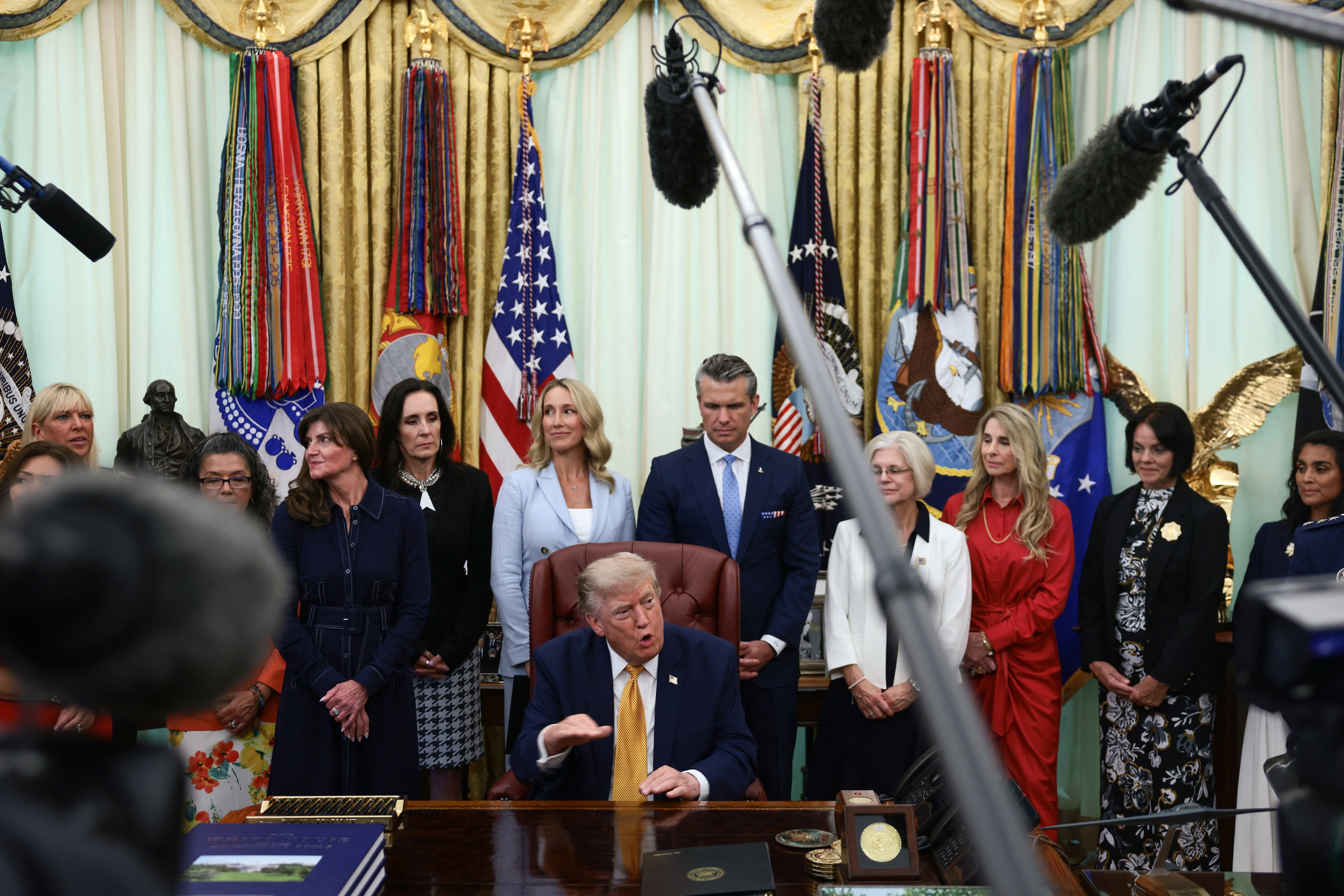 Trump gave his latest remarks on Iran surrounded by military spouses at the White House (Reuters)