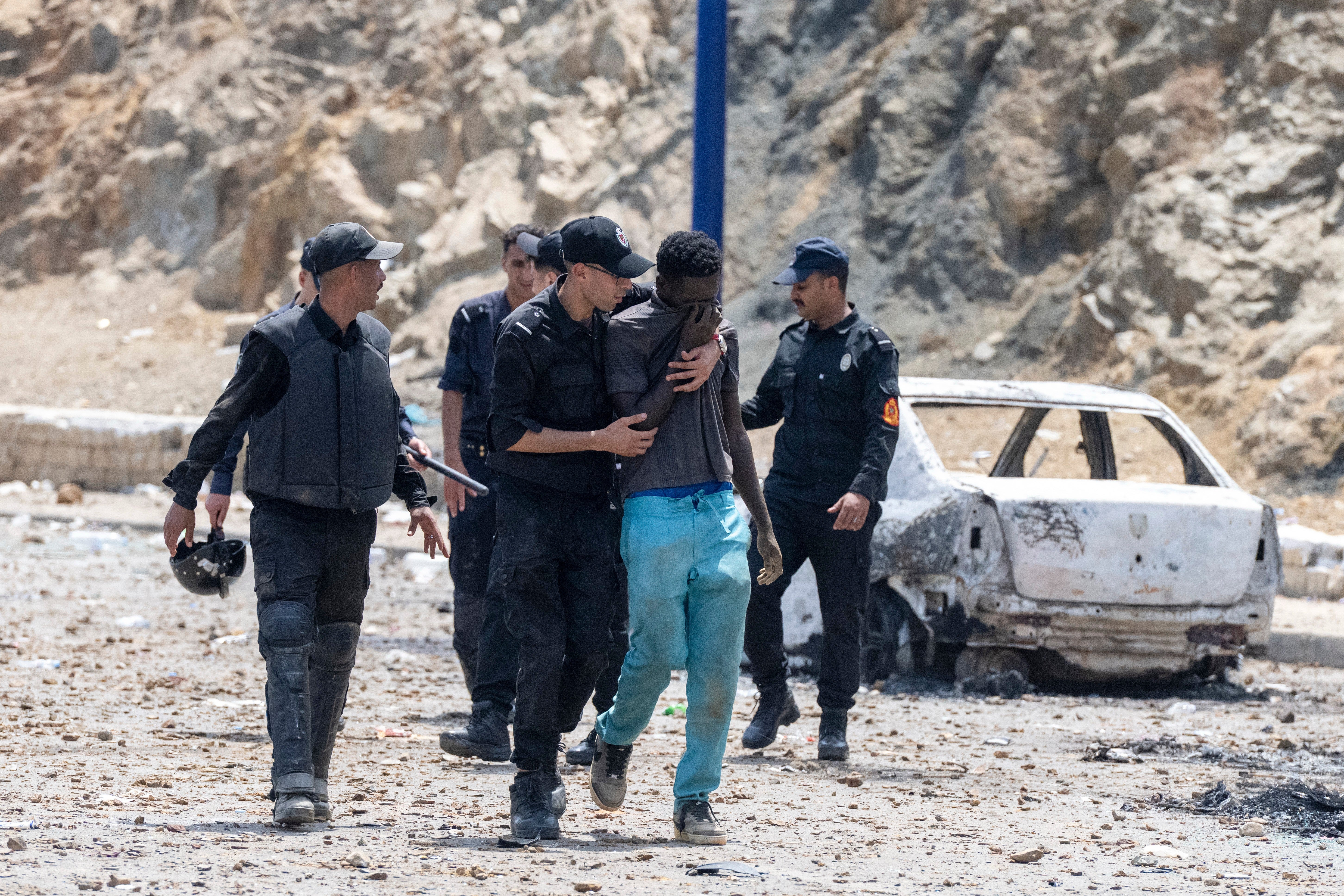 Moroccan security forces detain a man attempting to cross from the Moroccan northern town of Fnideq to the Spanish enclave of Ceuta, Friday, July 31, 2026. (AP Photo) (Copyright 2026 The Associated Press. All rights reserved)