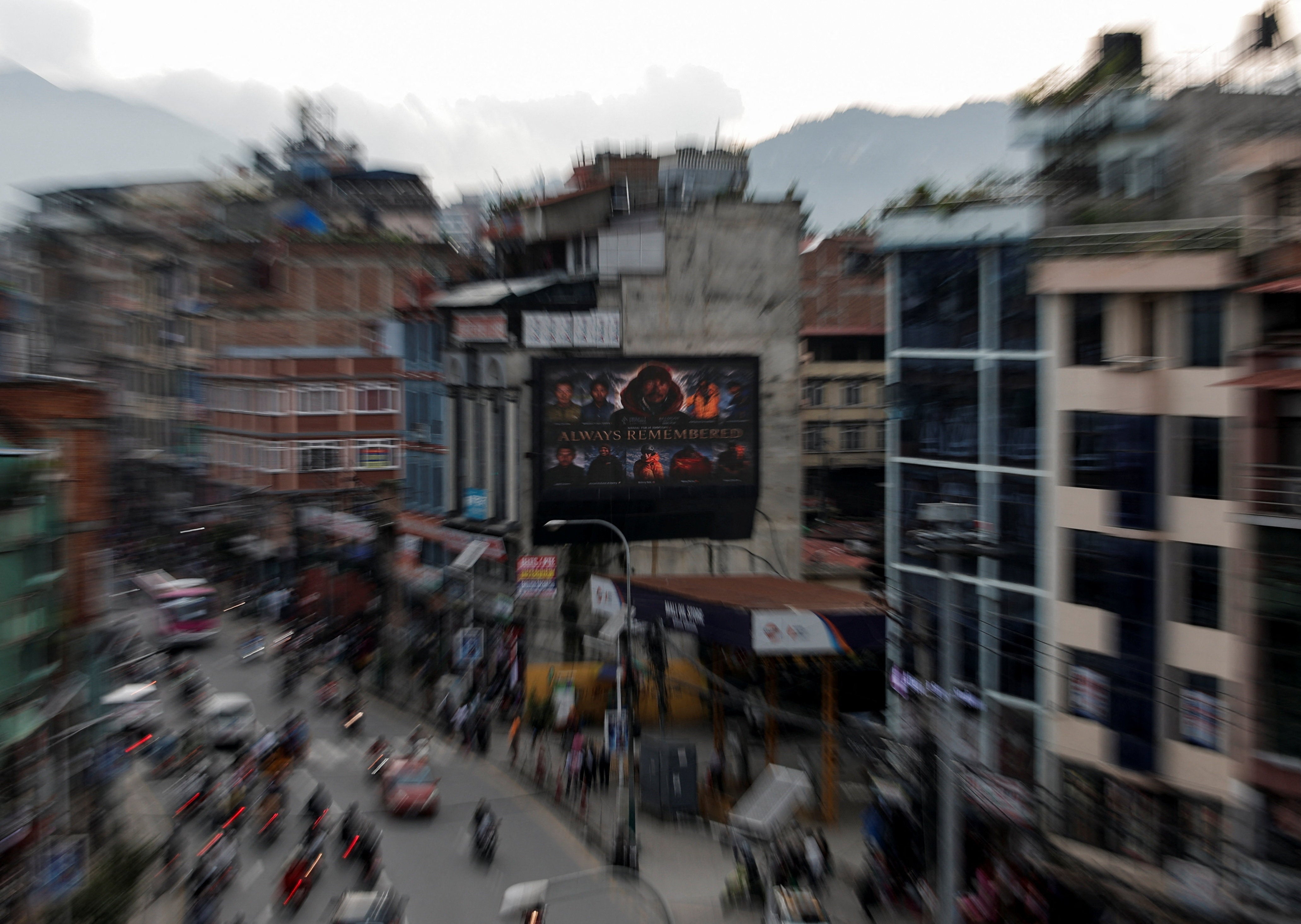 A digital board in Kathmandu displays a condolence message along with pictures of the climbers who lost their lives on Broad Peak (Reuters)