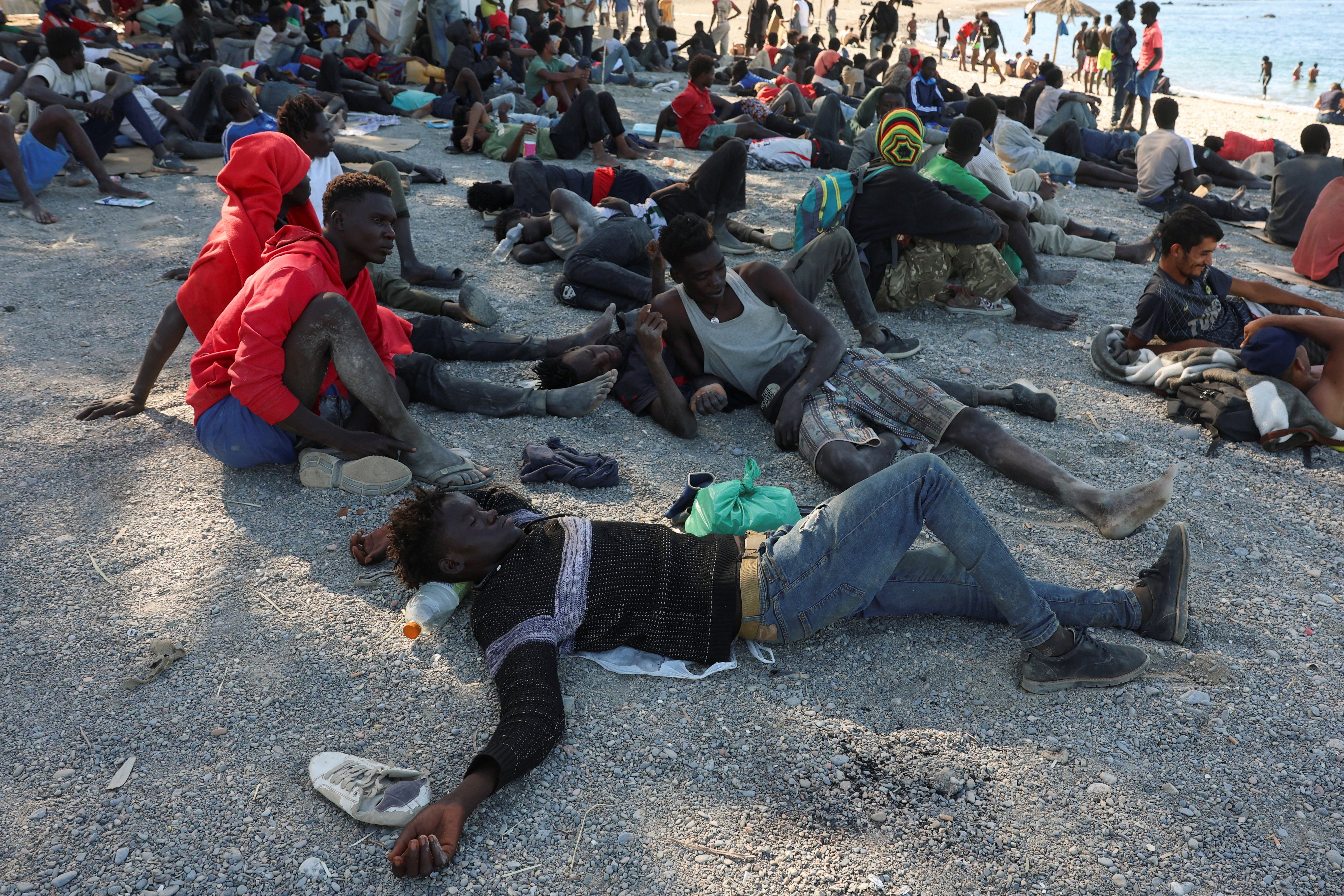 Migrants wait at a beach in Ceuta, Spain, following deadly mass crossings of migrants on foot and by sea from Morocco into Spanish territory, August 3, 2026. REUTERS/Violeta Santos Moura (Reuters)