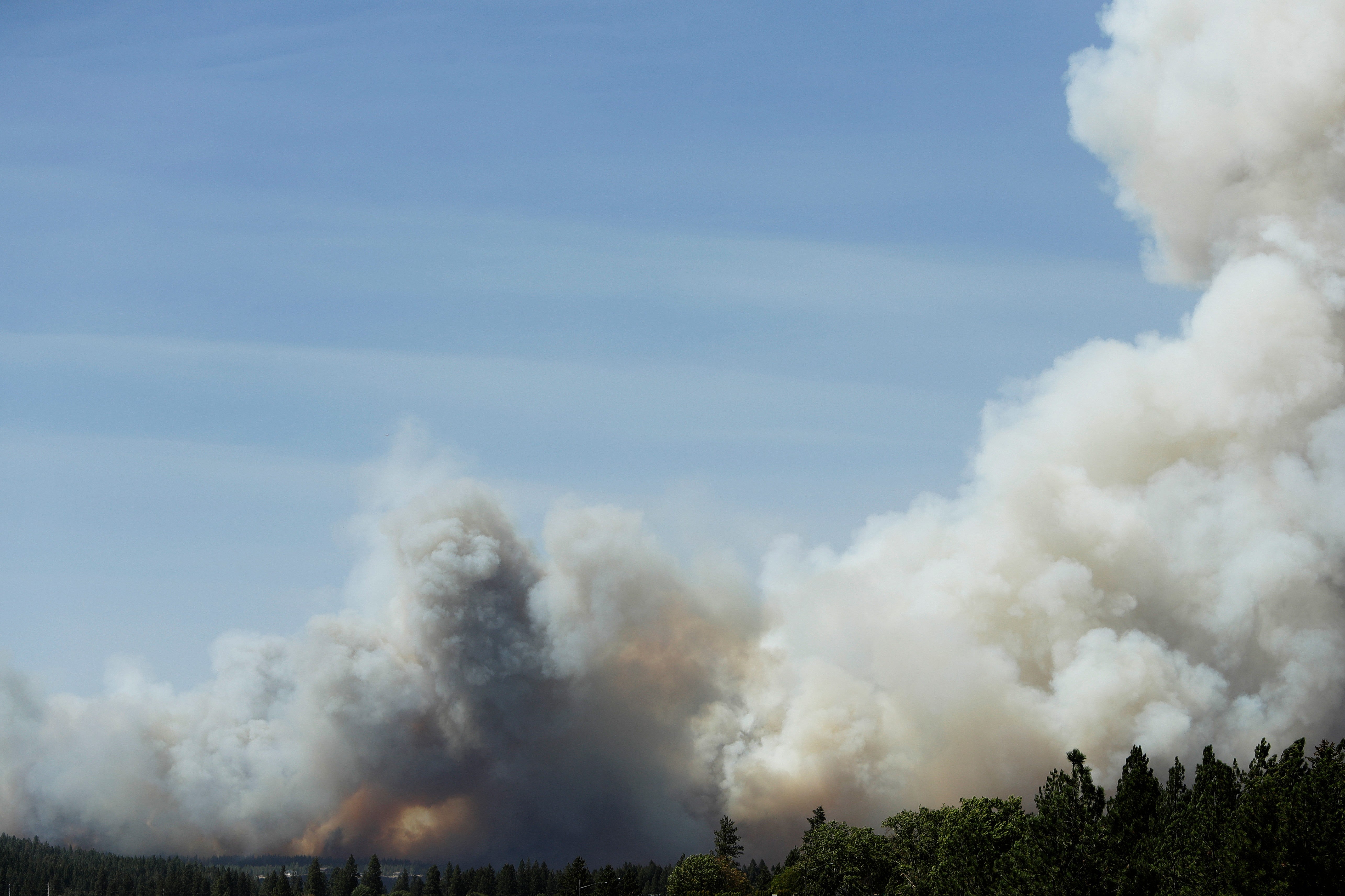 The Old Trails Fire sparked Saturday northwest of downtown Spokane, eventually jumping over the Spokane River and ripping through neighborhoods (AP)