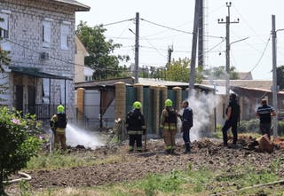 Rescuers work at a site of a Russian missile strike