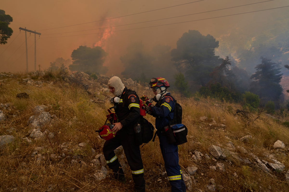 Firefighters work to contain blazes outside Athens as winds and heat expected