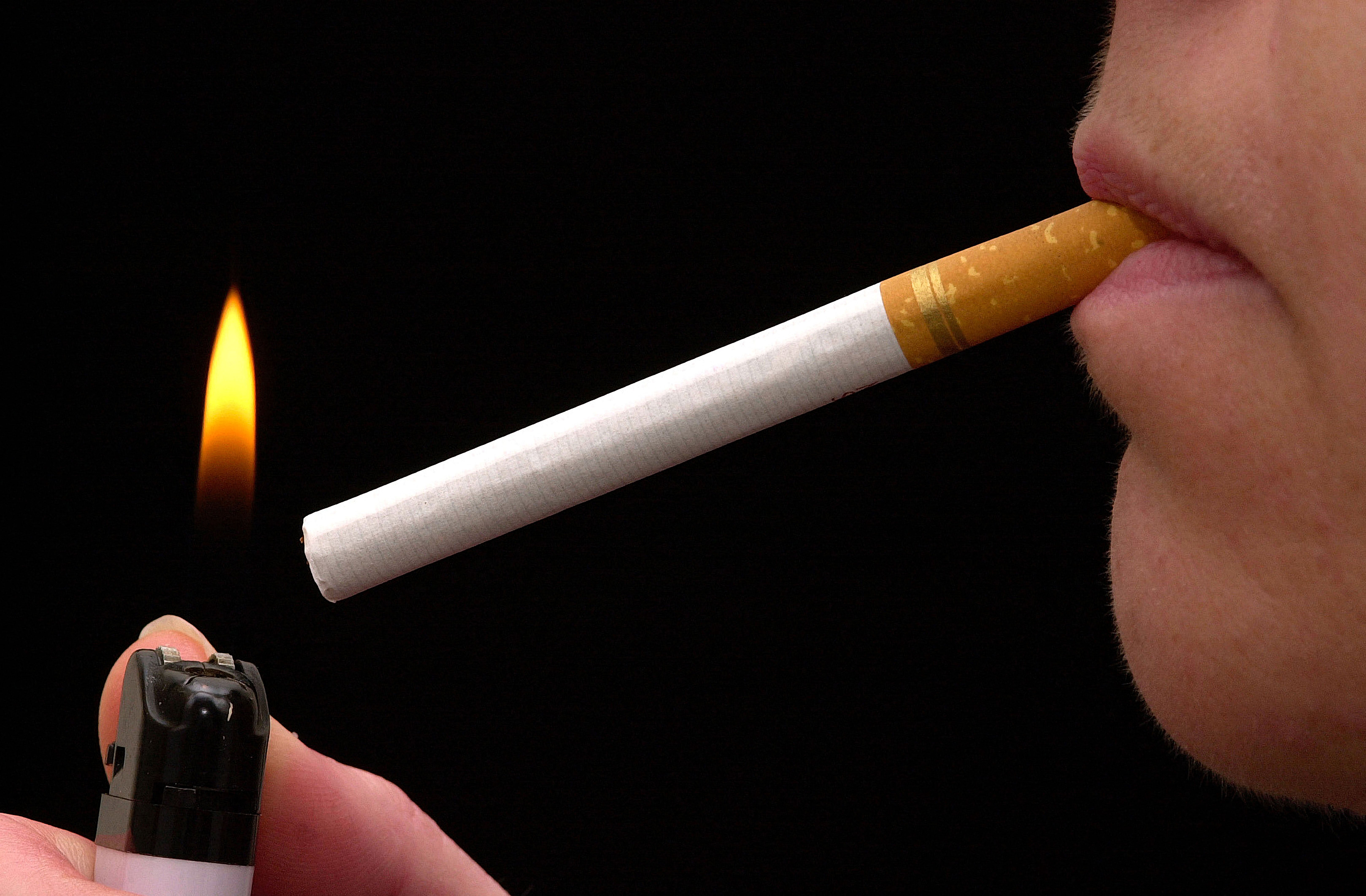 Close up picture of woman lighting up a cigarette