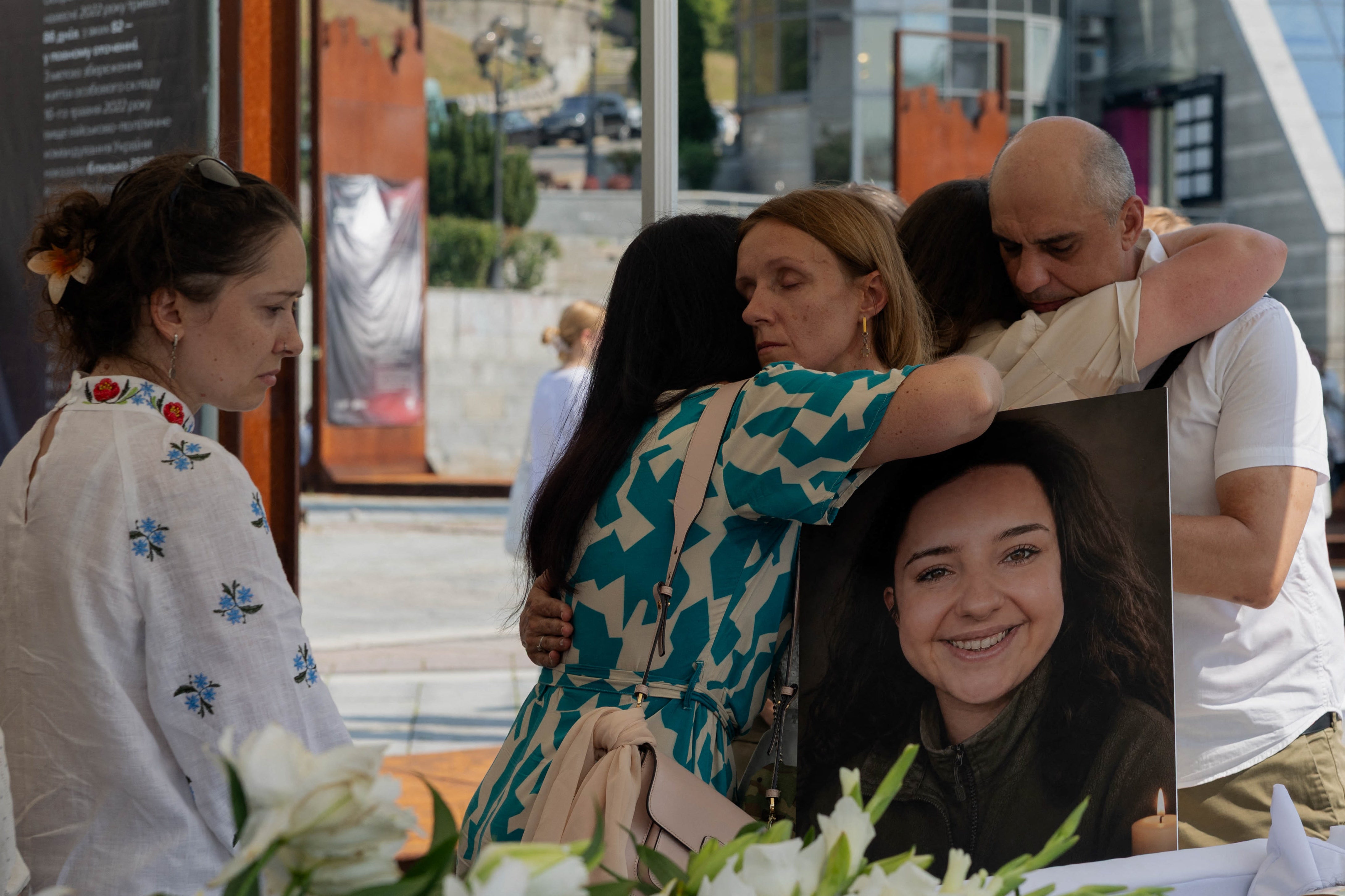 Relatives and friends mourn at the coffin of Vitalina 