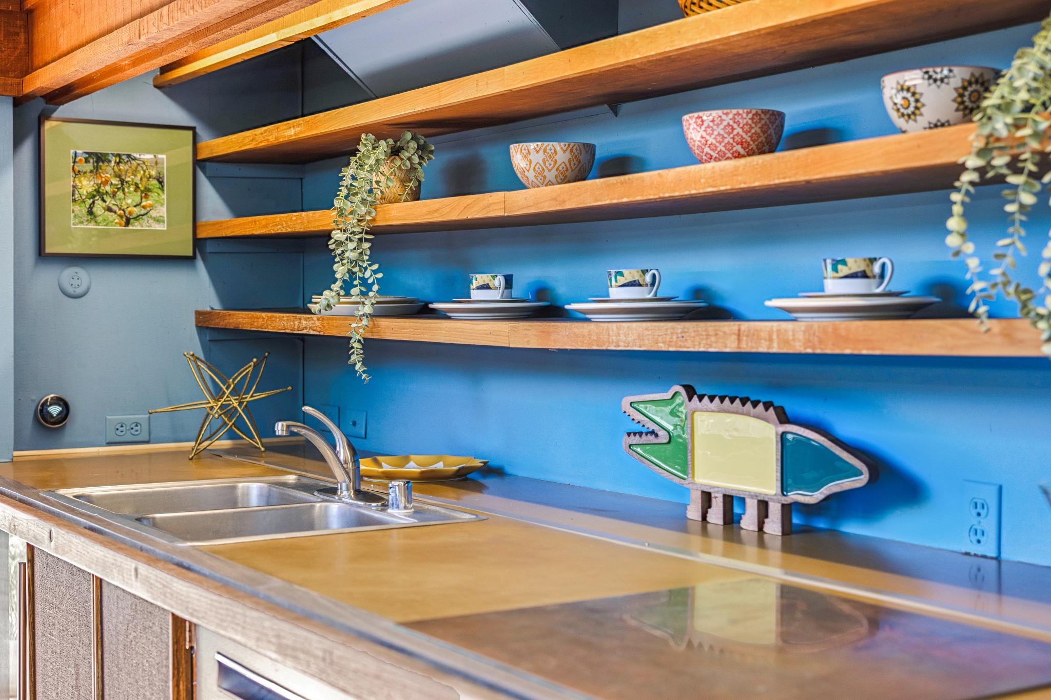 There’s a living room, bathroom and a galley kitchen with exposed wooden shelves and countertops on the first floor (Open Homes Photography)