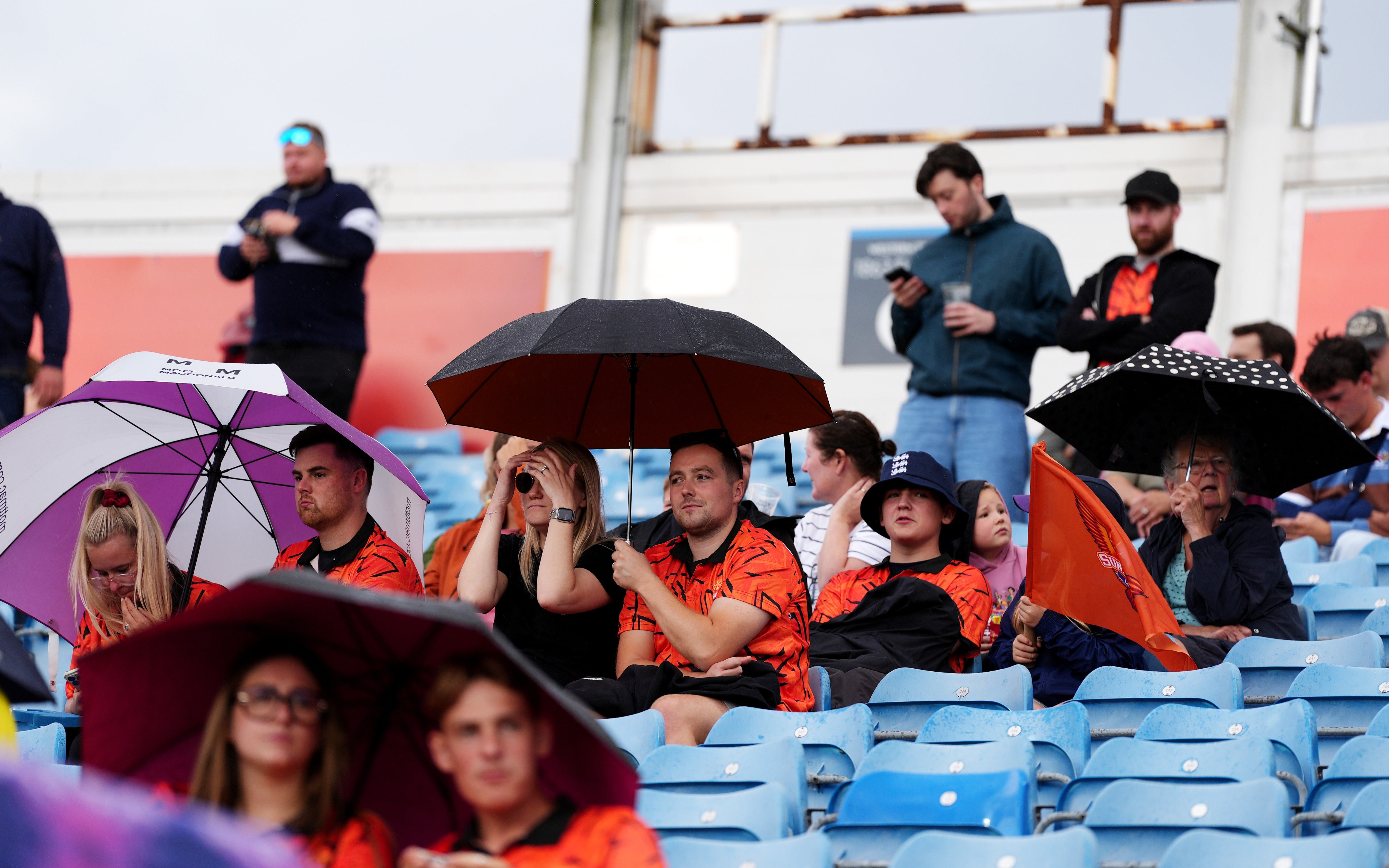 Spectators using umbrellas to shelter from the rain ahead of The Hundred men's cricket match at Headingley, Leeds (Annabel Lee-Ellis/PA Wire)